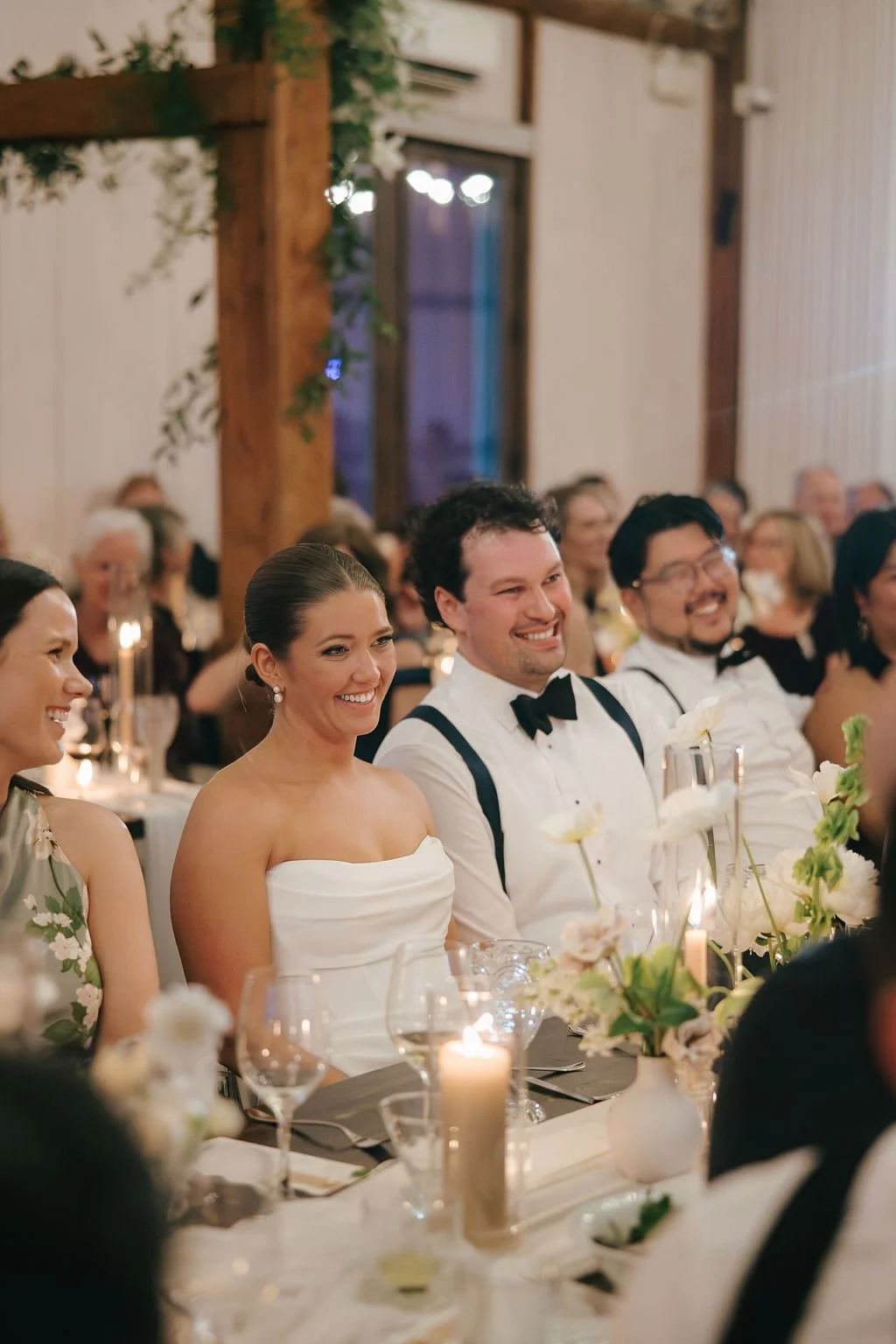 Bride and groom laughing with guests at their wedding reception