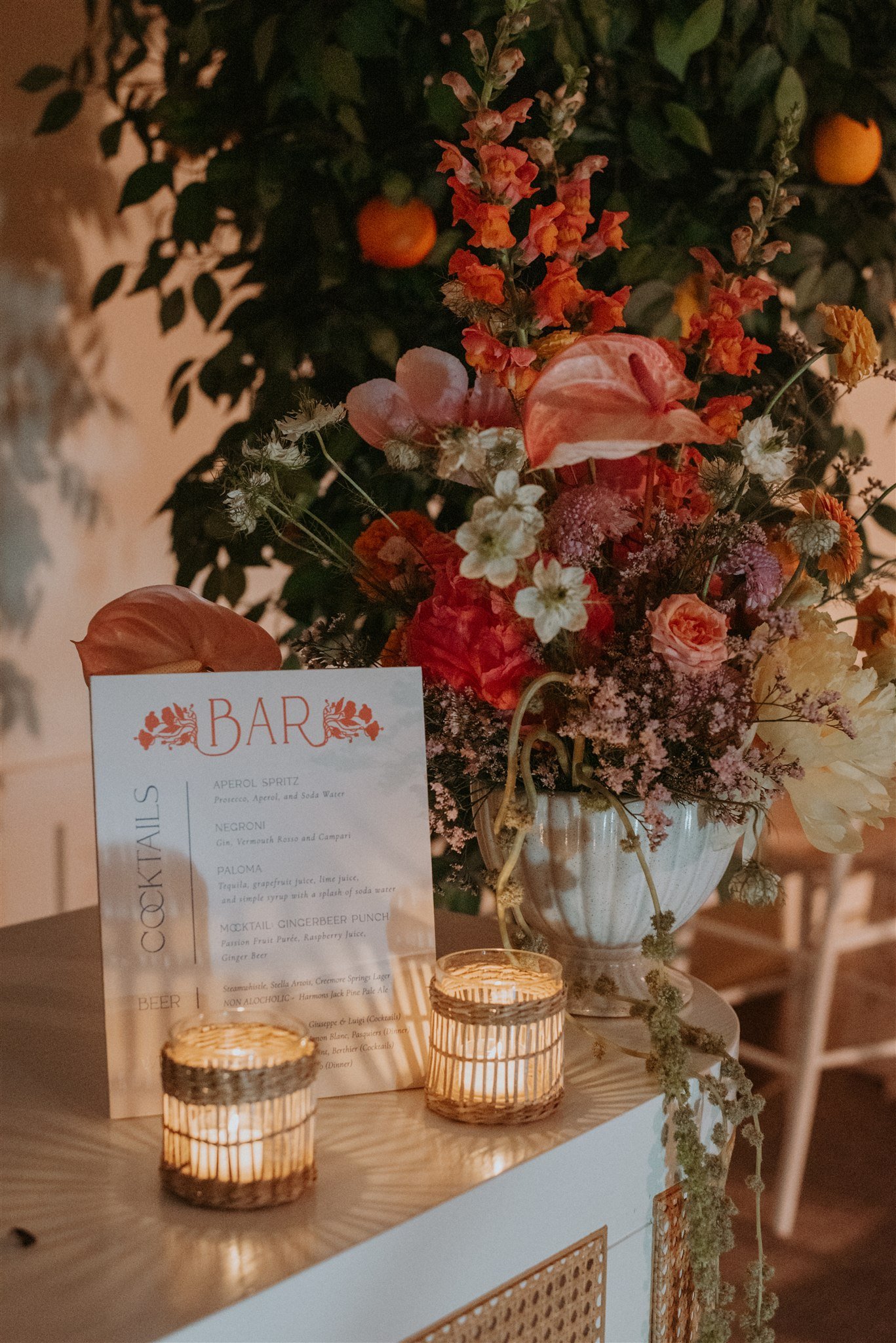 Organic floral arrangement with hand-threaded oranges by Wild Vogel Works