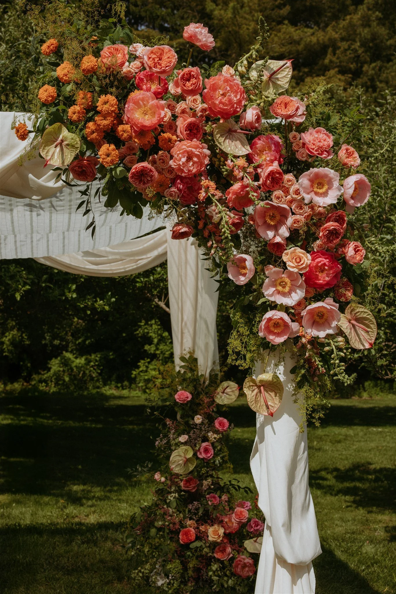 Asymmetrical chuppah with peach and blush florals