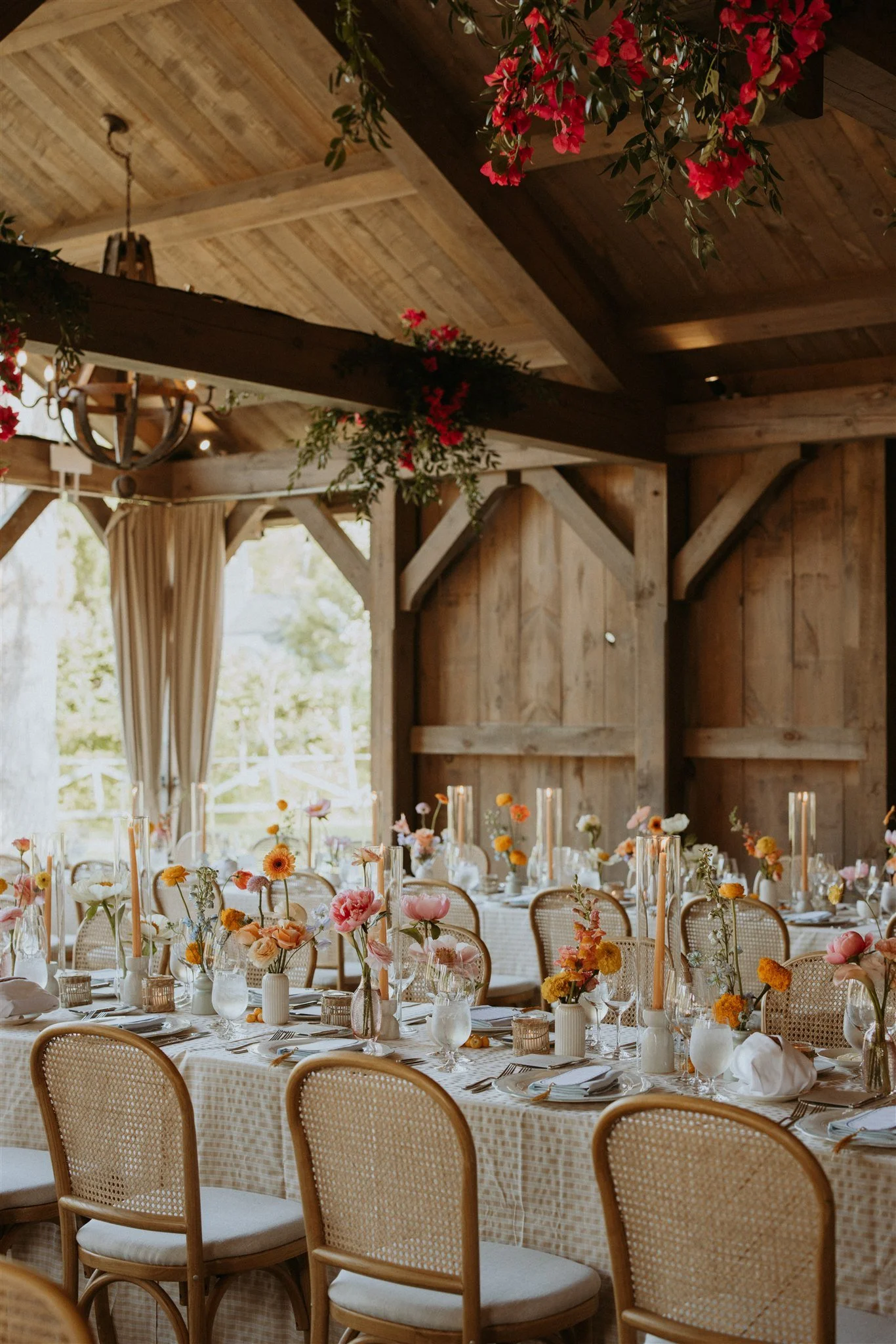Florals and greenery hanging from the beams of the Summer House at Langdon Hall