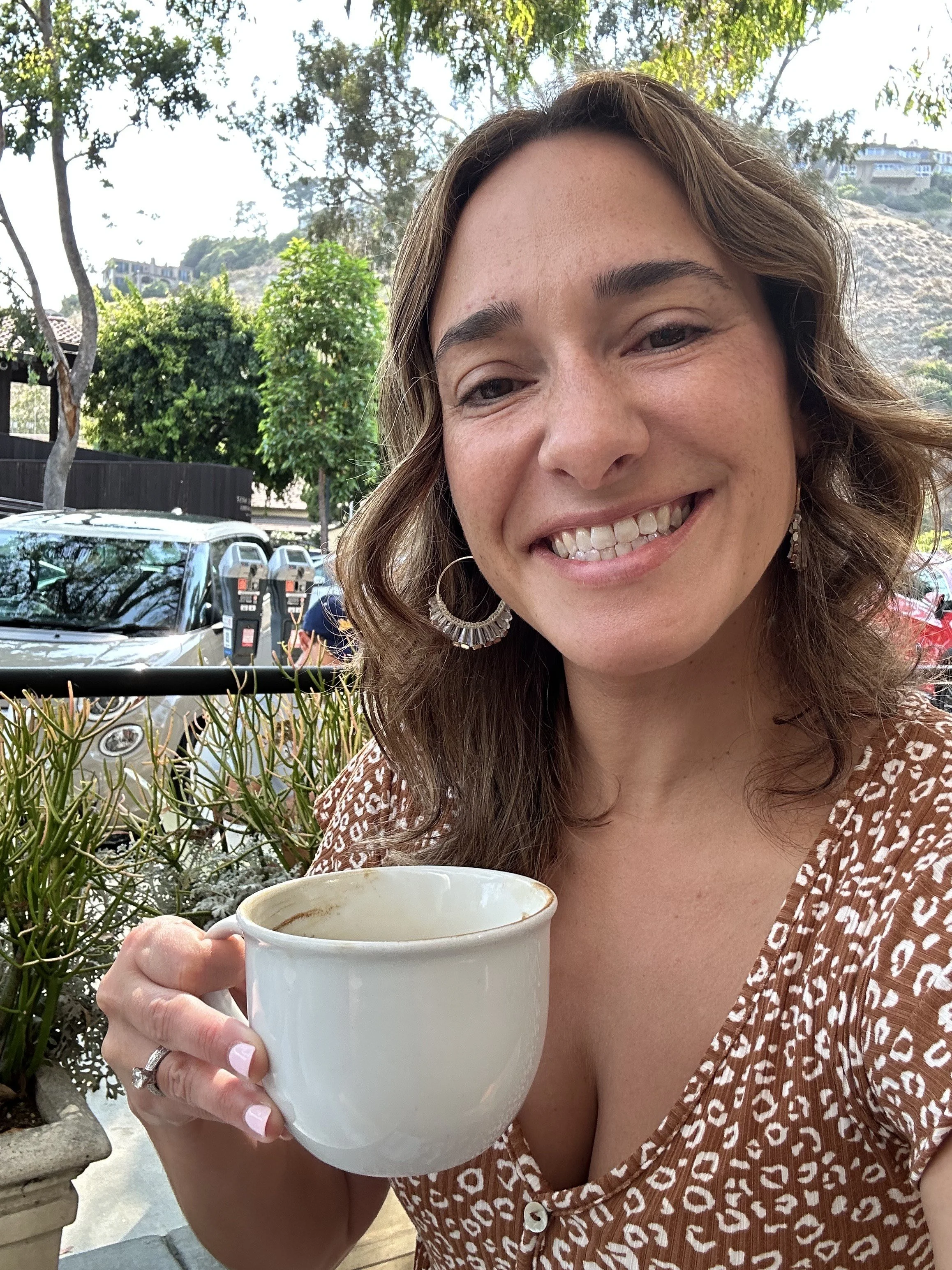 Diana sipping coffee on her Monthly Money Date