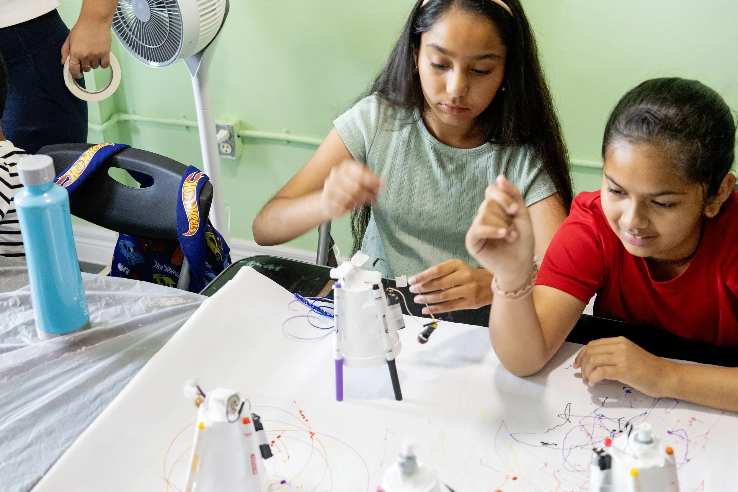 Campers creating dancing robots from recycled materials