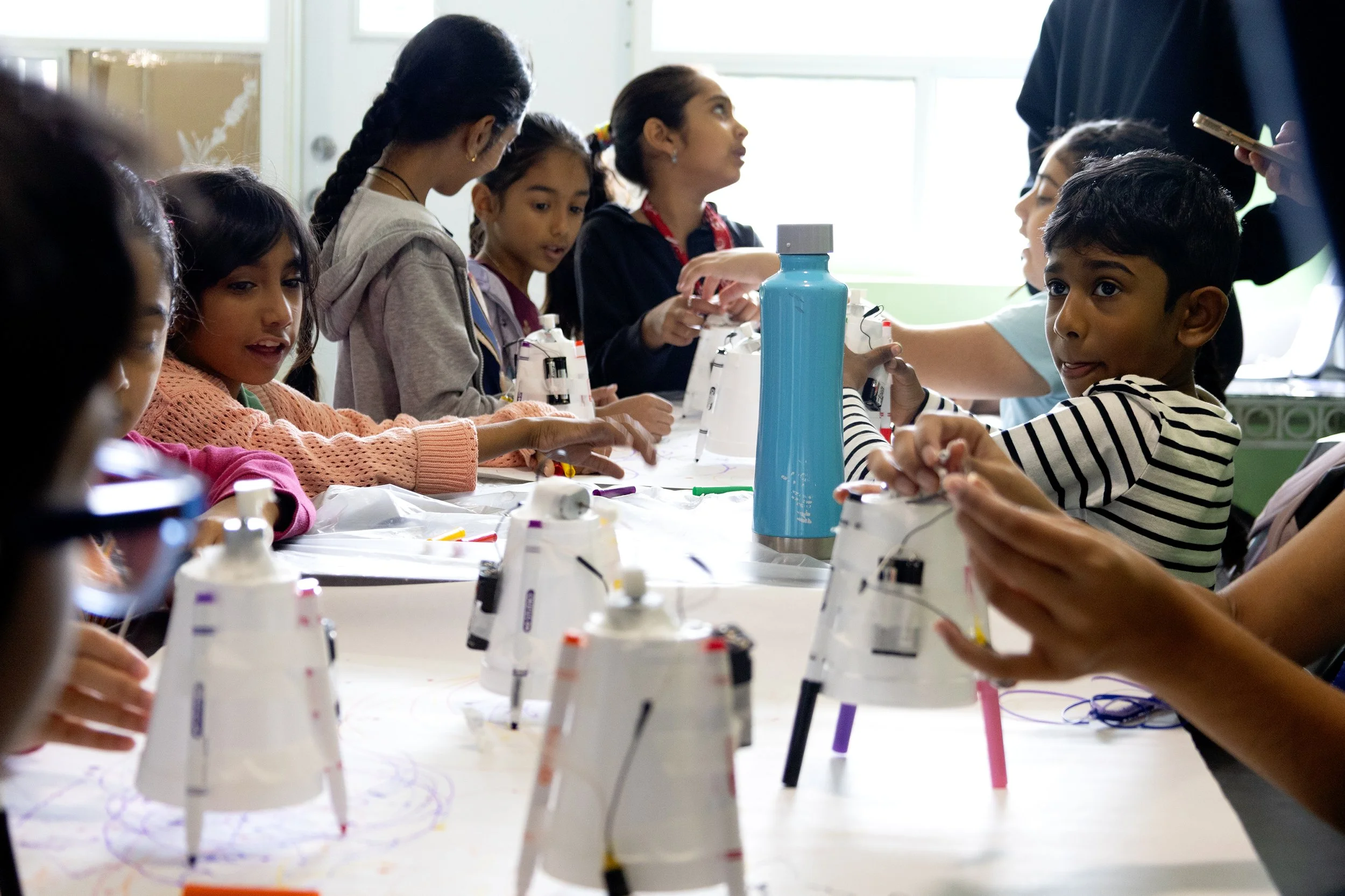 Campers creating dancing robots from recycled materials