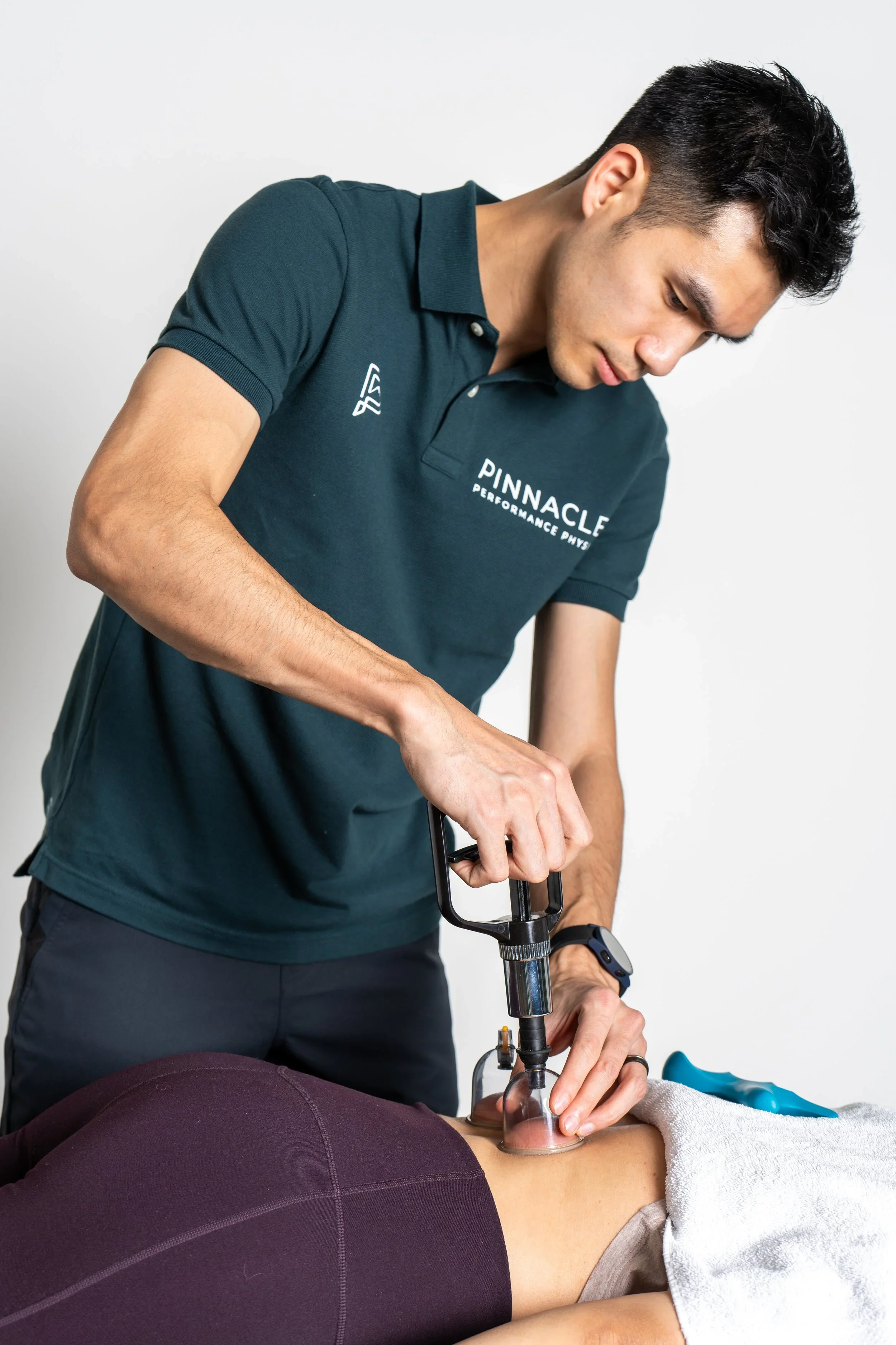 Physical therapist performing cupping technique on patient's shoulder at Bellevue physical therapy clinic