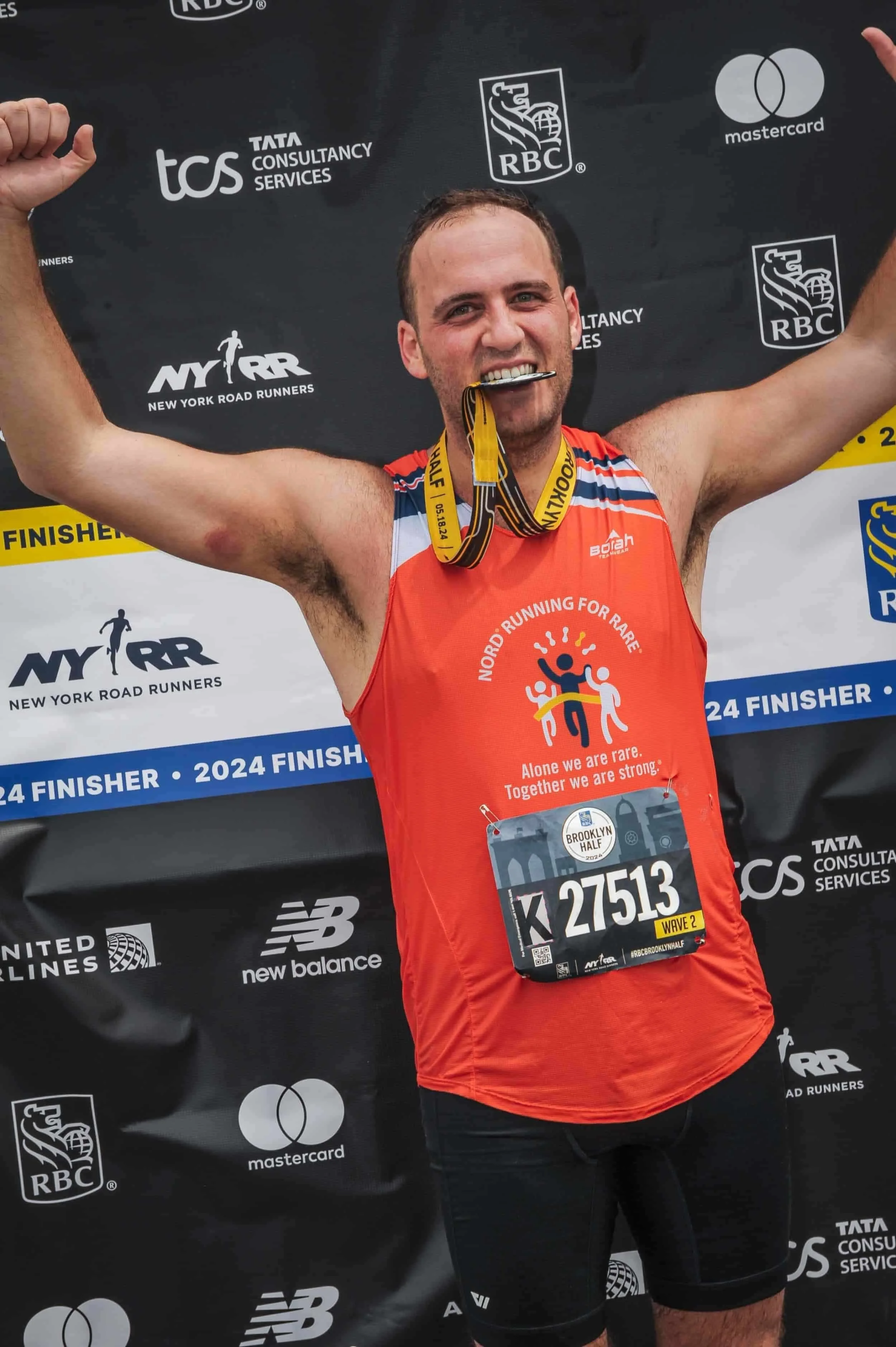 Steve at the Brooklyn Half finish biting his medal