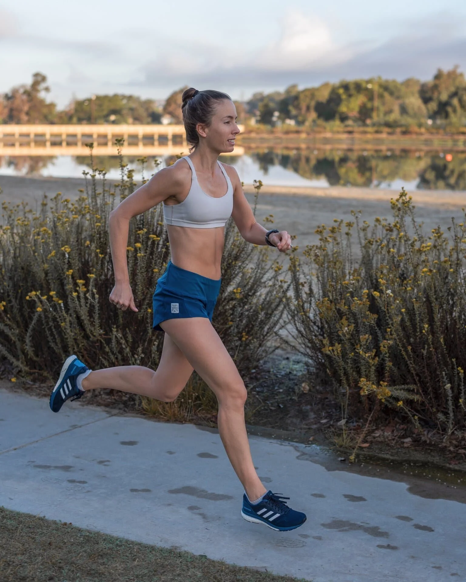 Woman running on path next to a lake