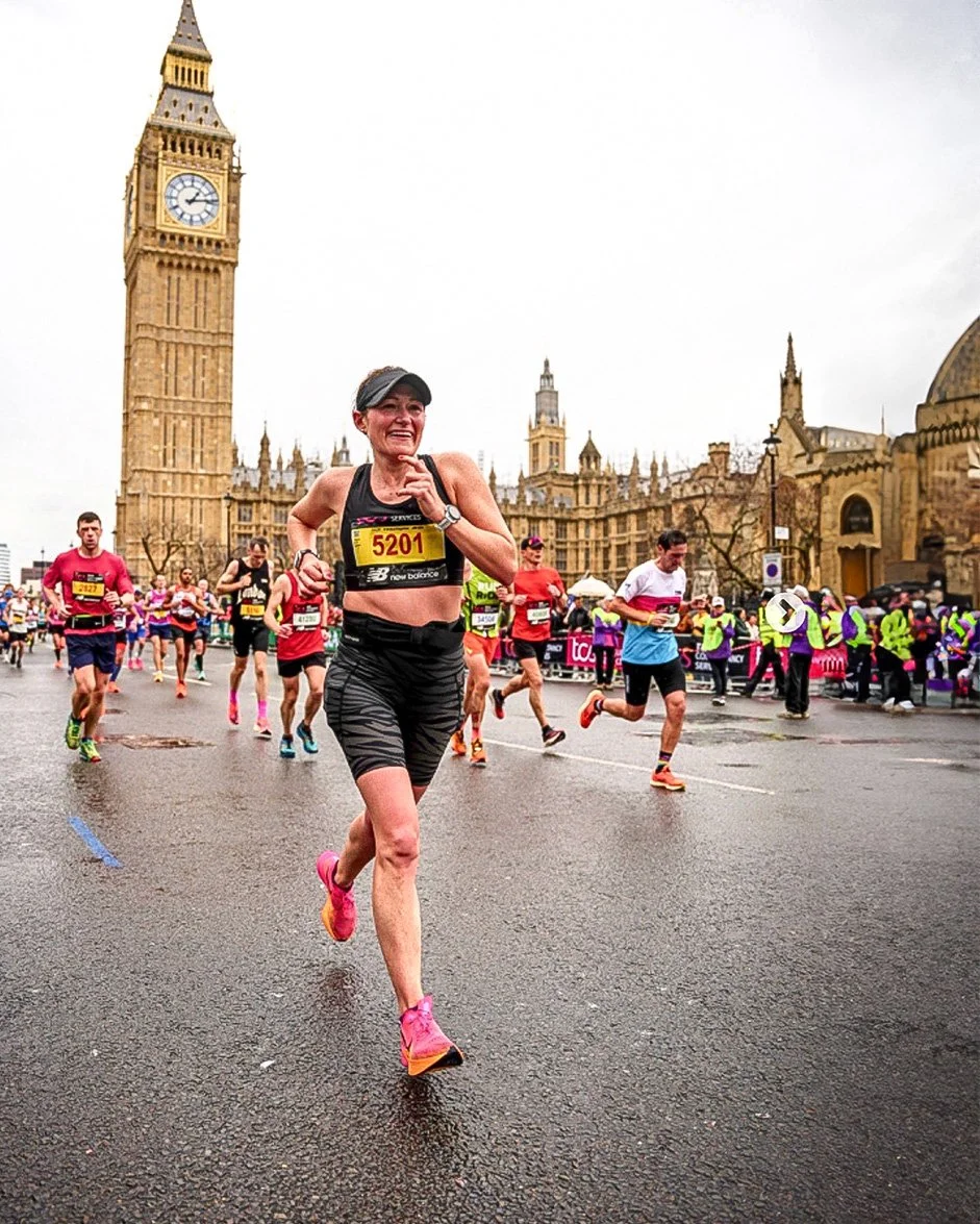 Rachel running by Big Ben in London with a huge smile on her face!