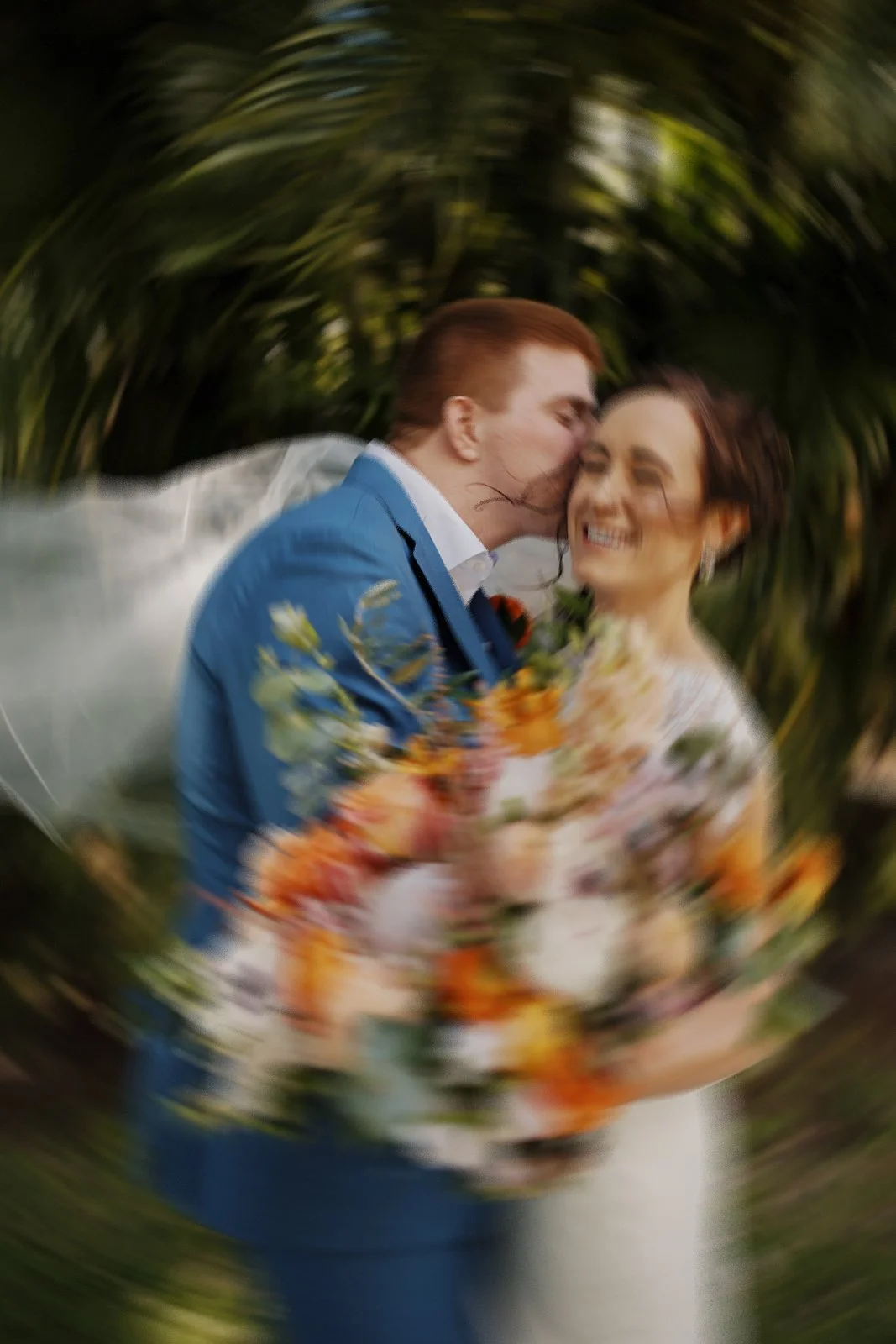 Embracing Couple Amidst Tropical Foliage