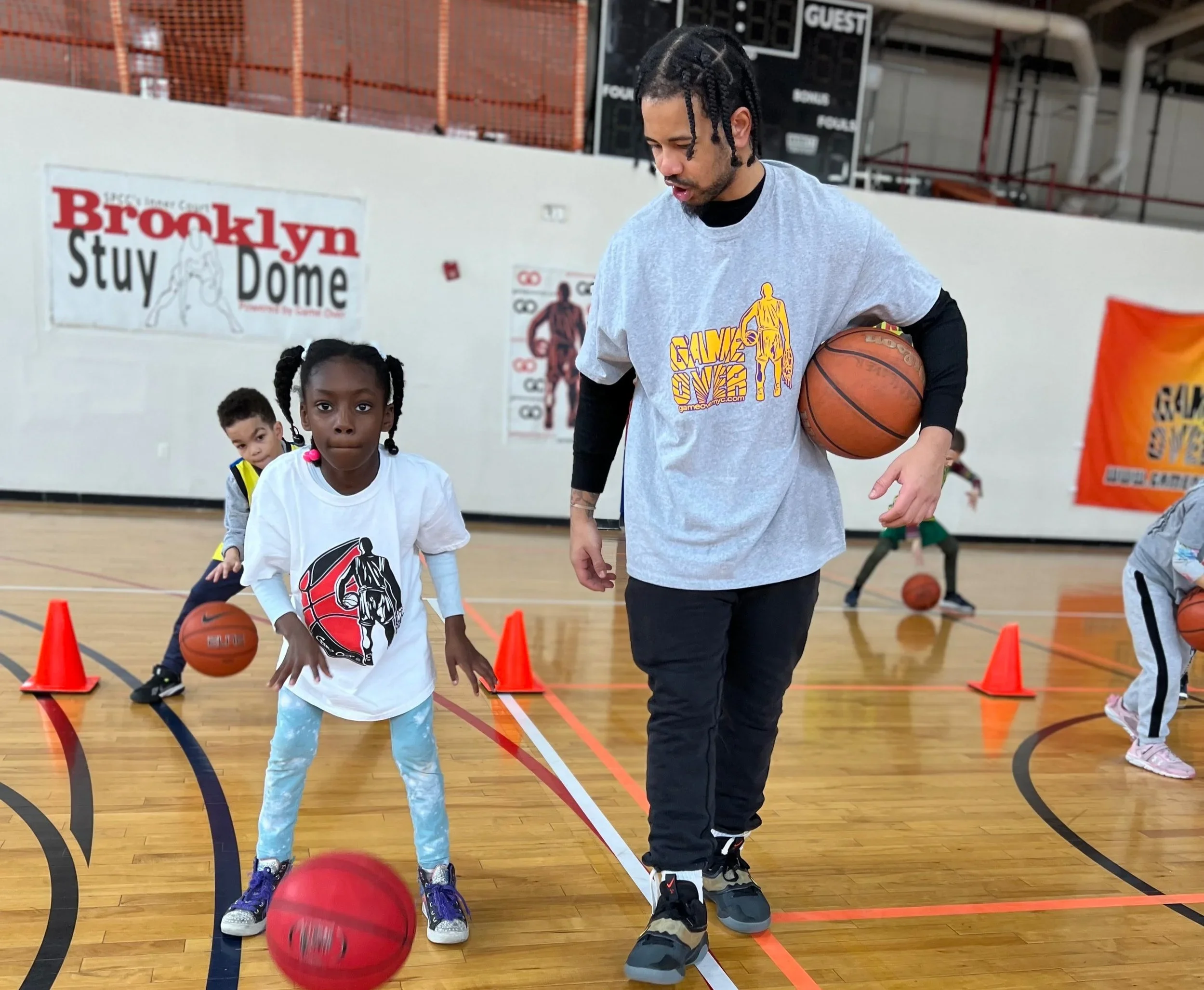Photo of kids participating in a basketball camp or coding class.