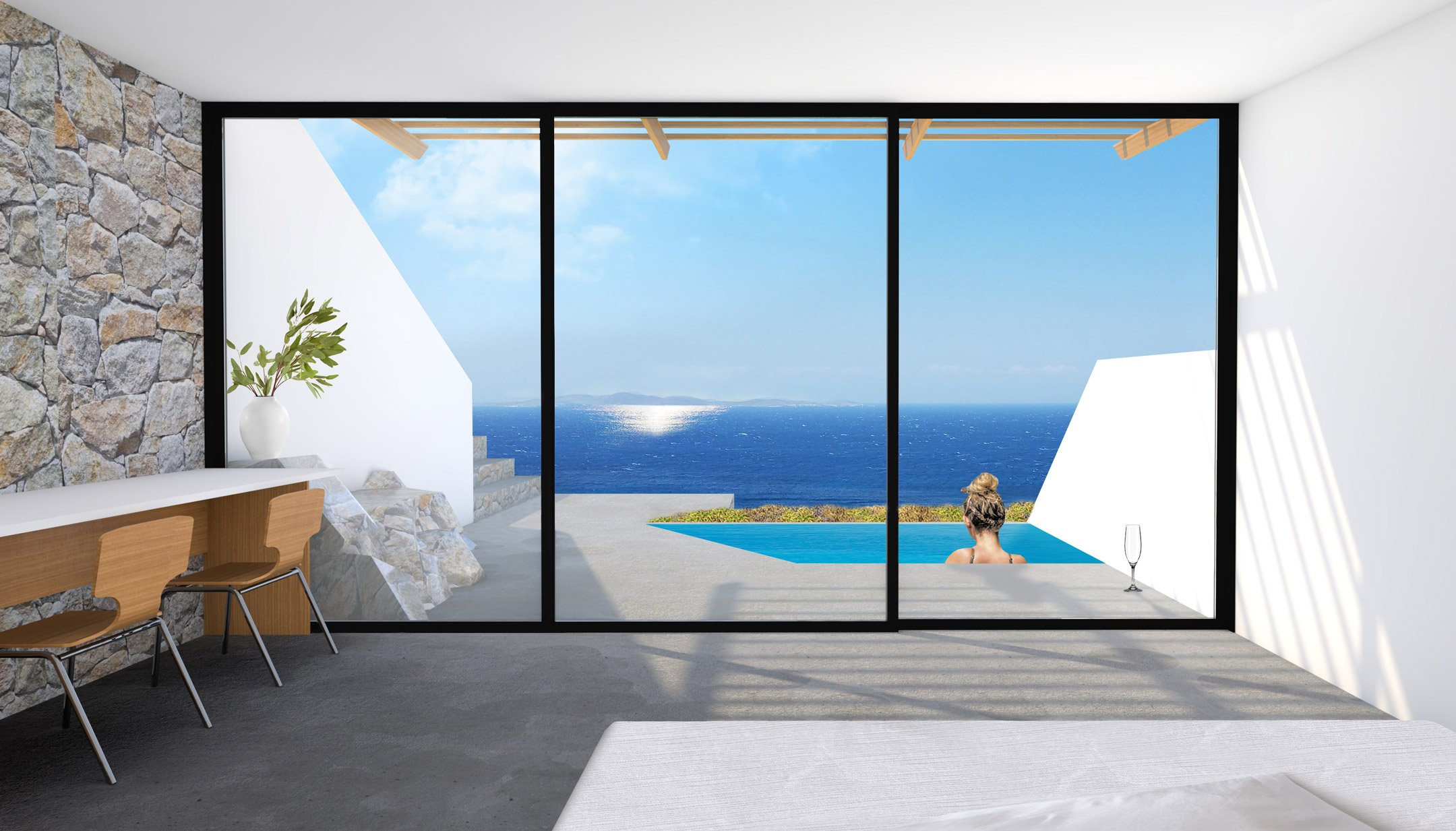 Modern interior living space with a large glass sliding door opening to a patio with a pool, overlooking the ocean; includes a stone wall, a white vase with green plants, and wooden chairs.
