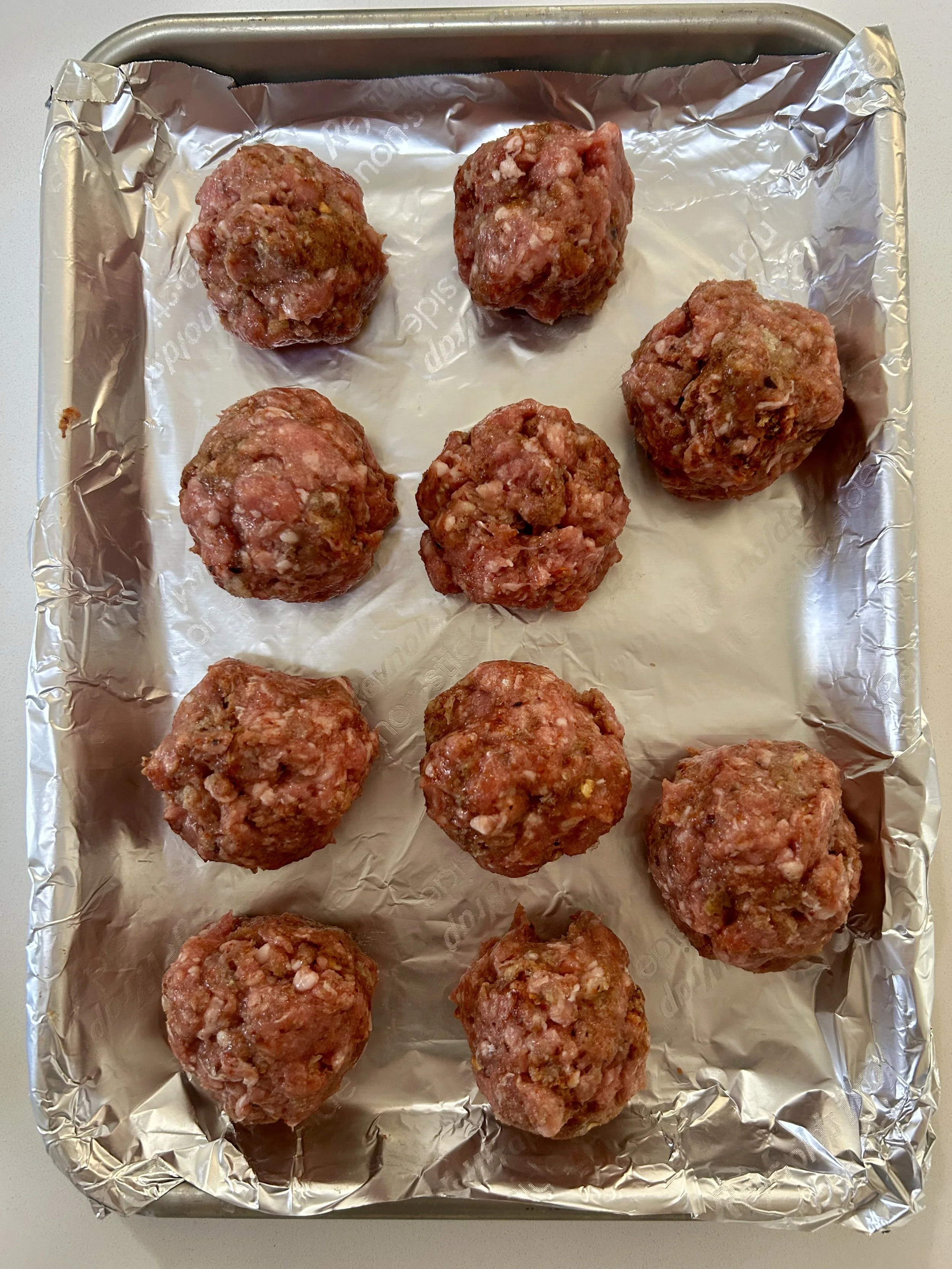 Spicy lamb meatballs seasoned and ready to bake in the oven