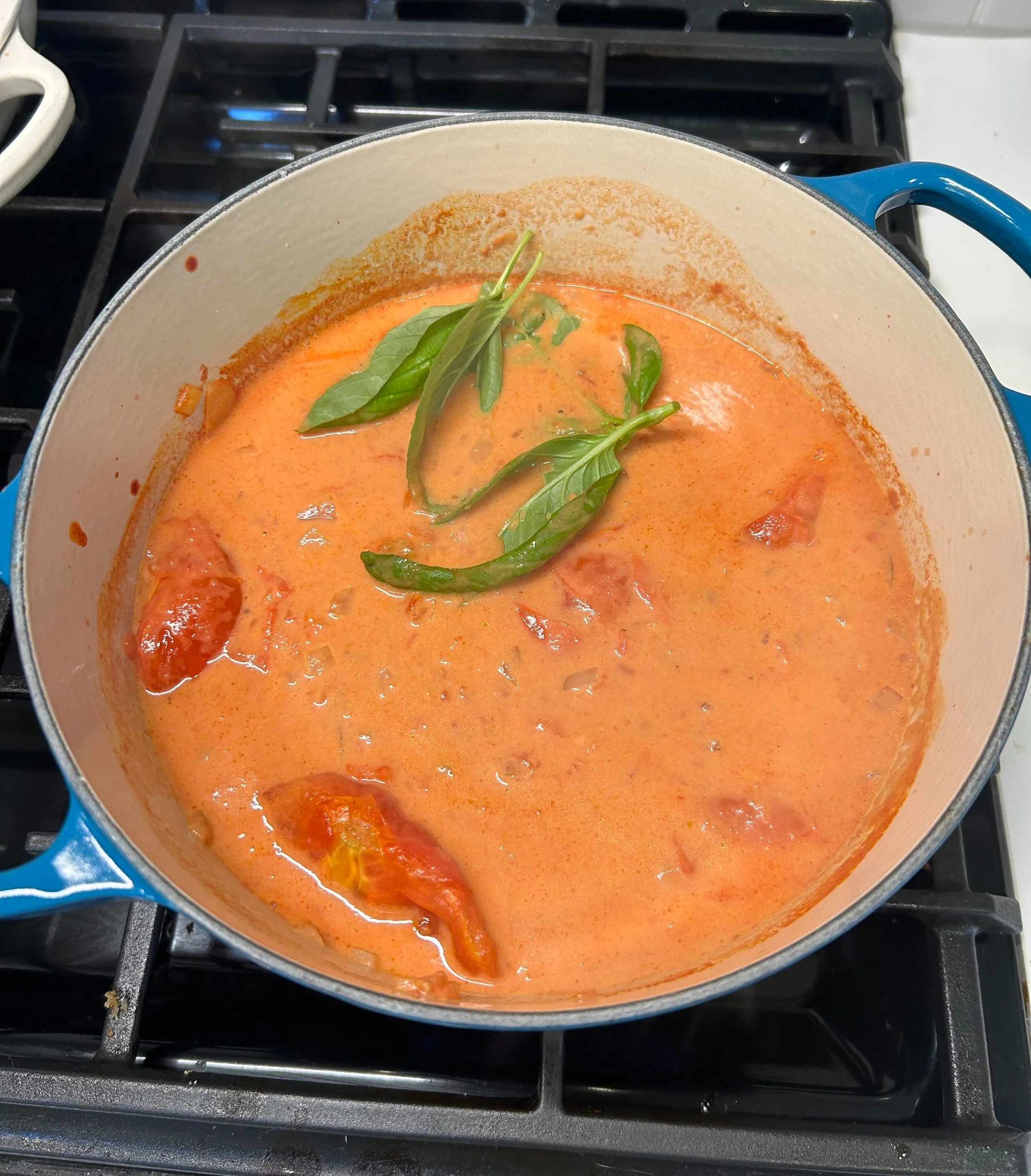 Tomato soup with coconut milk simmering on the stove