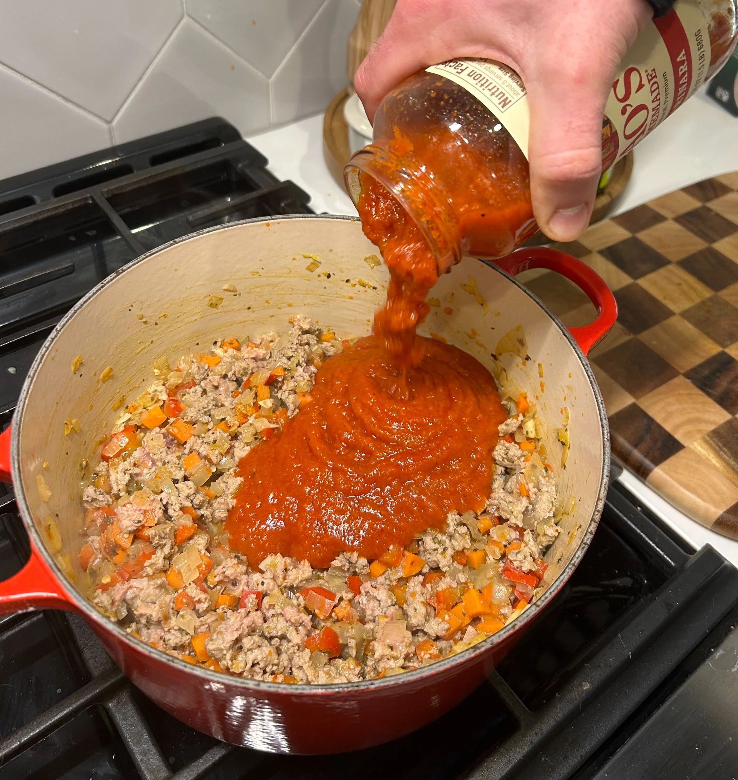 marinara being added to the lasagna soup base ingredients