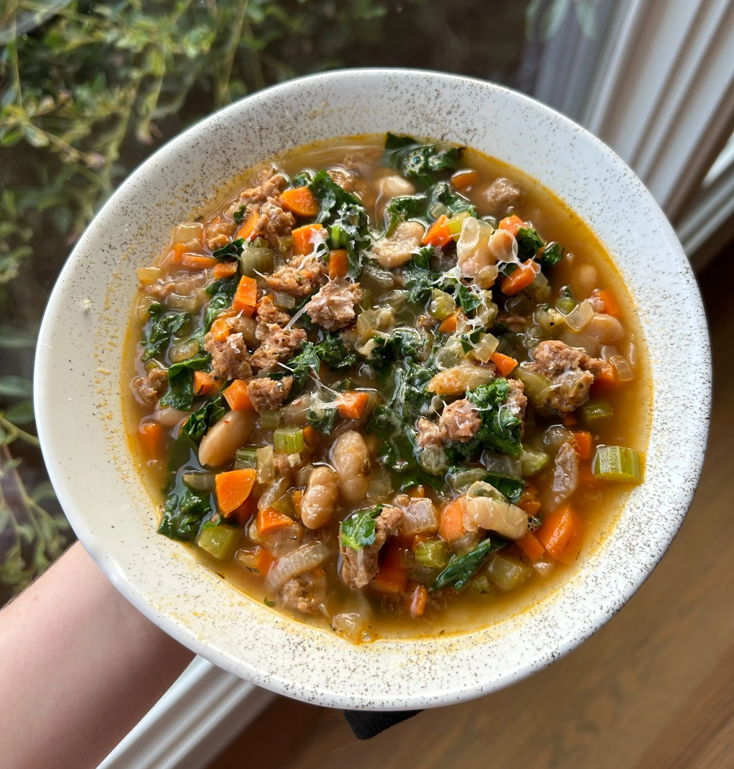 Sausage, kale, and white bean soup ready to eat for a cozy weeknight dinner