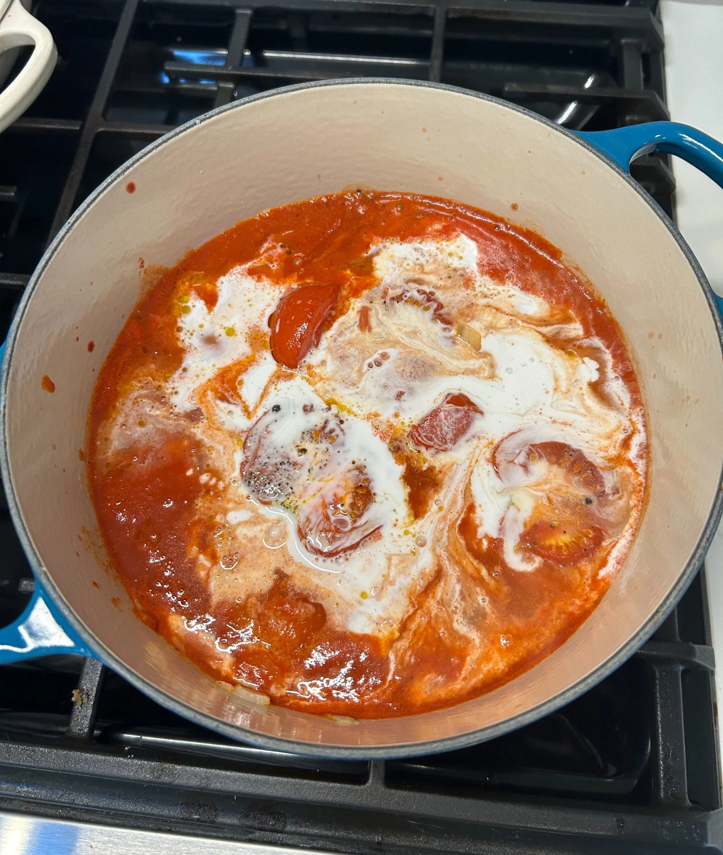 Tomato soup with coconut milk in the process of cooking