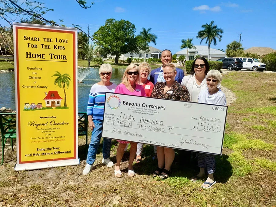 Ladies holding large check from Beyond Ourselves to A.N.A's Friends for $15,000