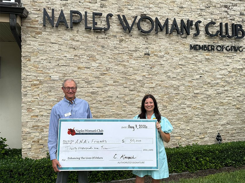 Man and Woman large holding check from Naples Woman's Club to A.N.A's Friends