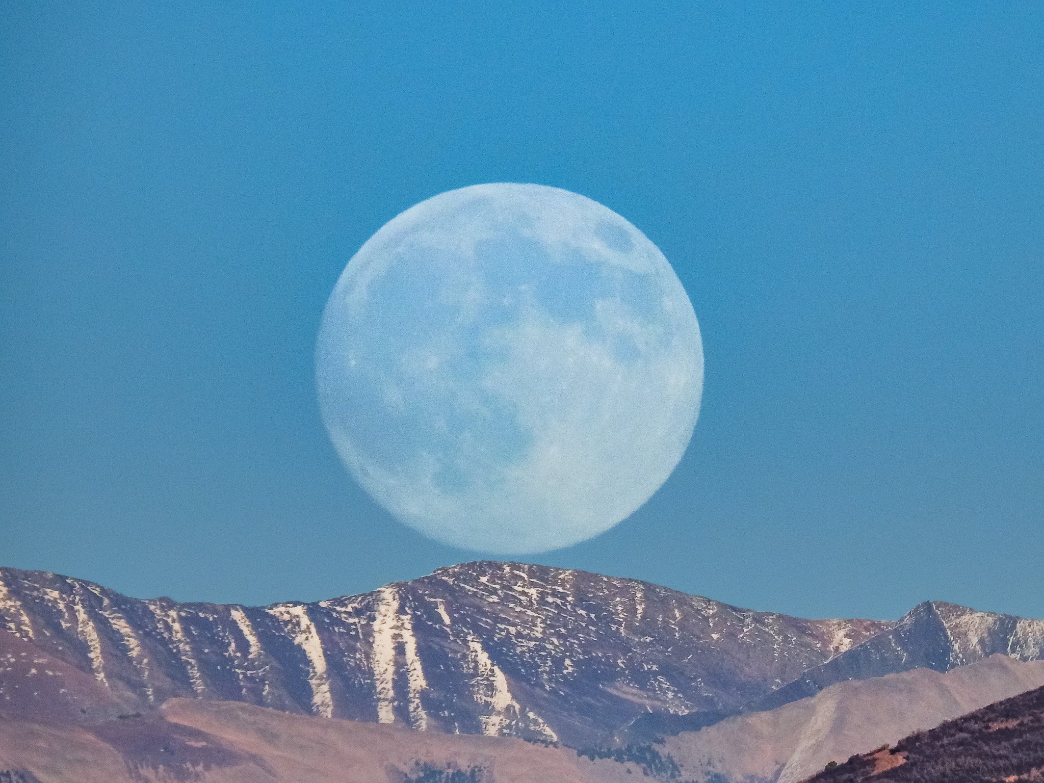 Full Beaver Moon rising over the Raggeds close-up