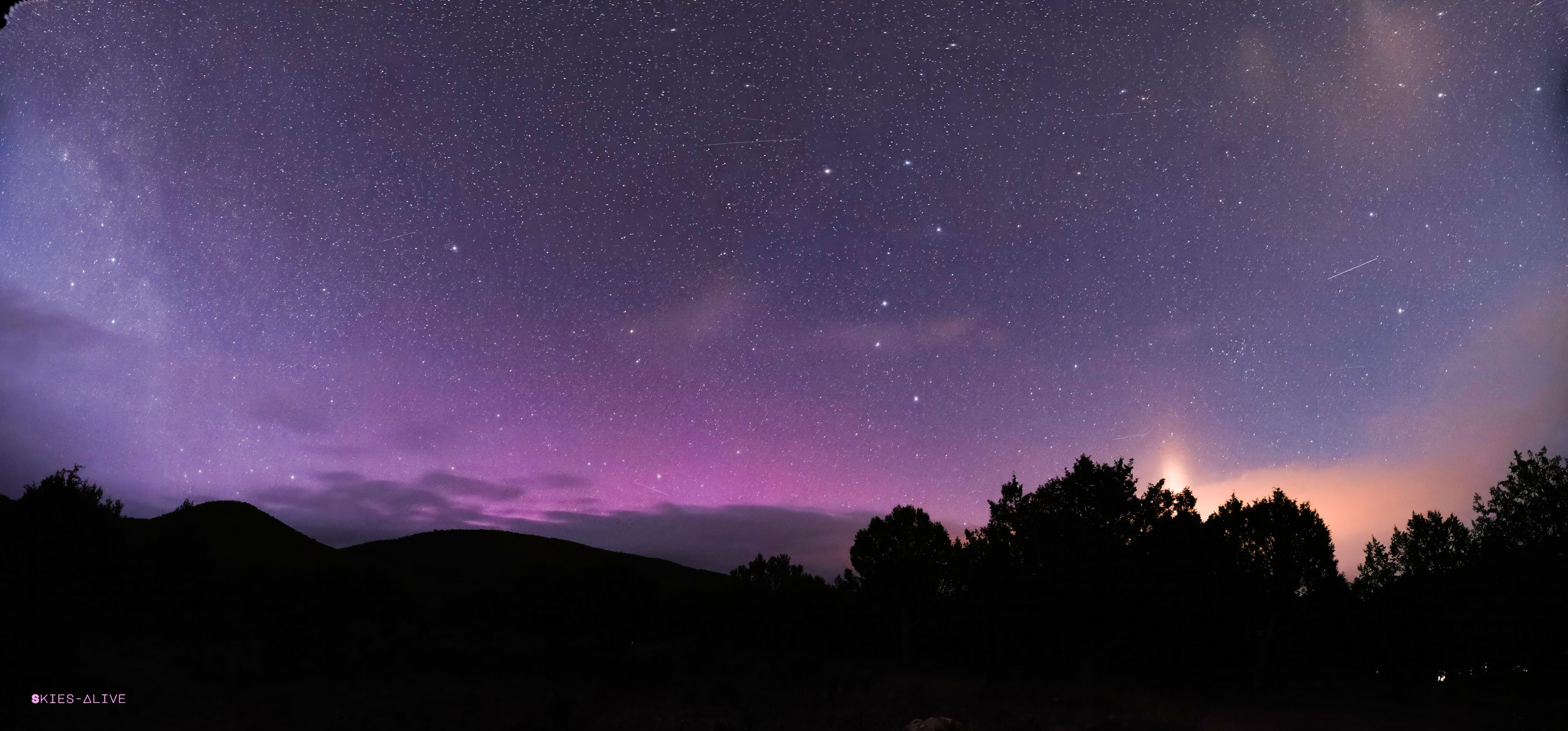 Panorama - pink and orange glows from natural and artificial light.