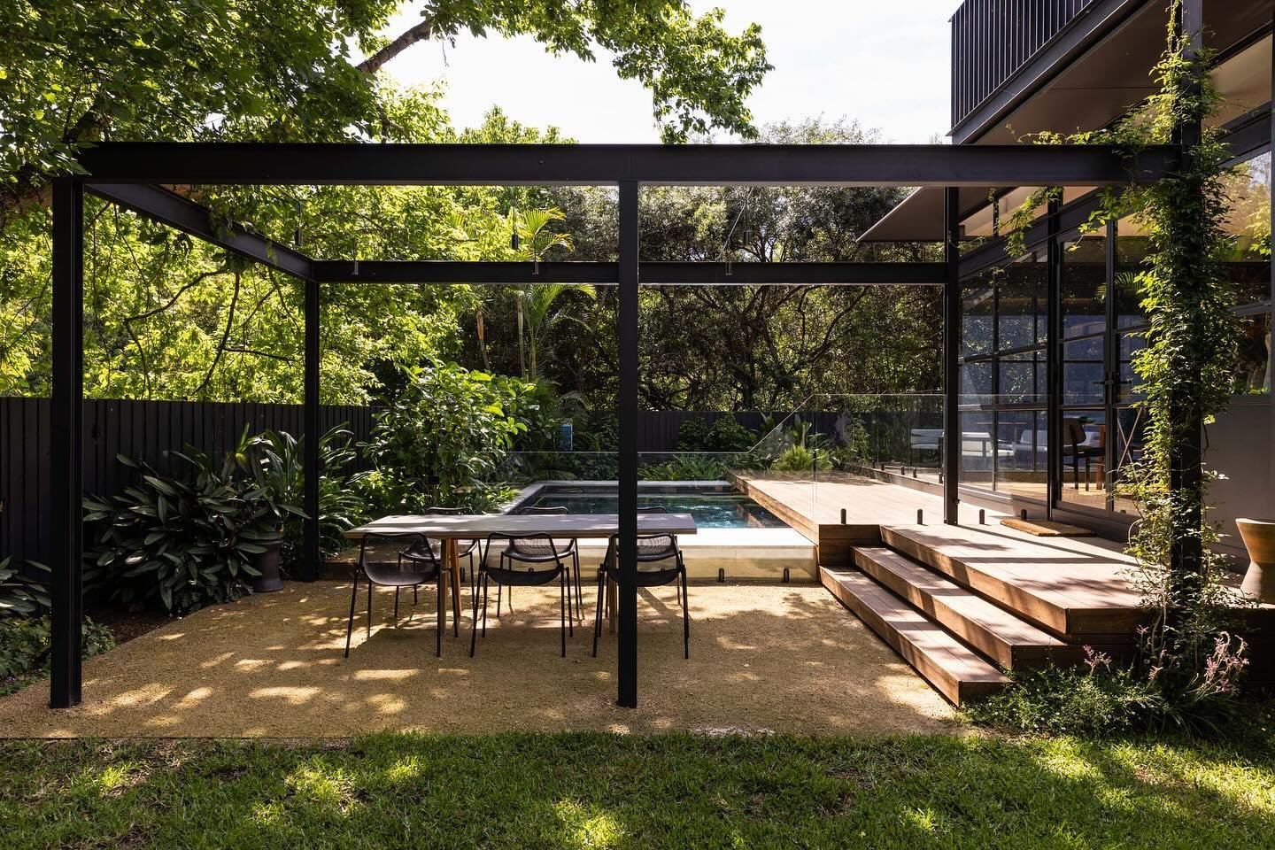 Building, pool &amp; garden connecting under the tree canopy.