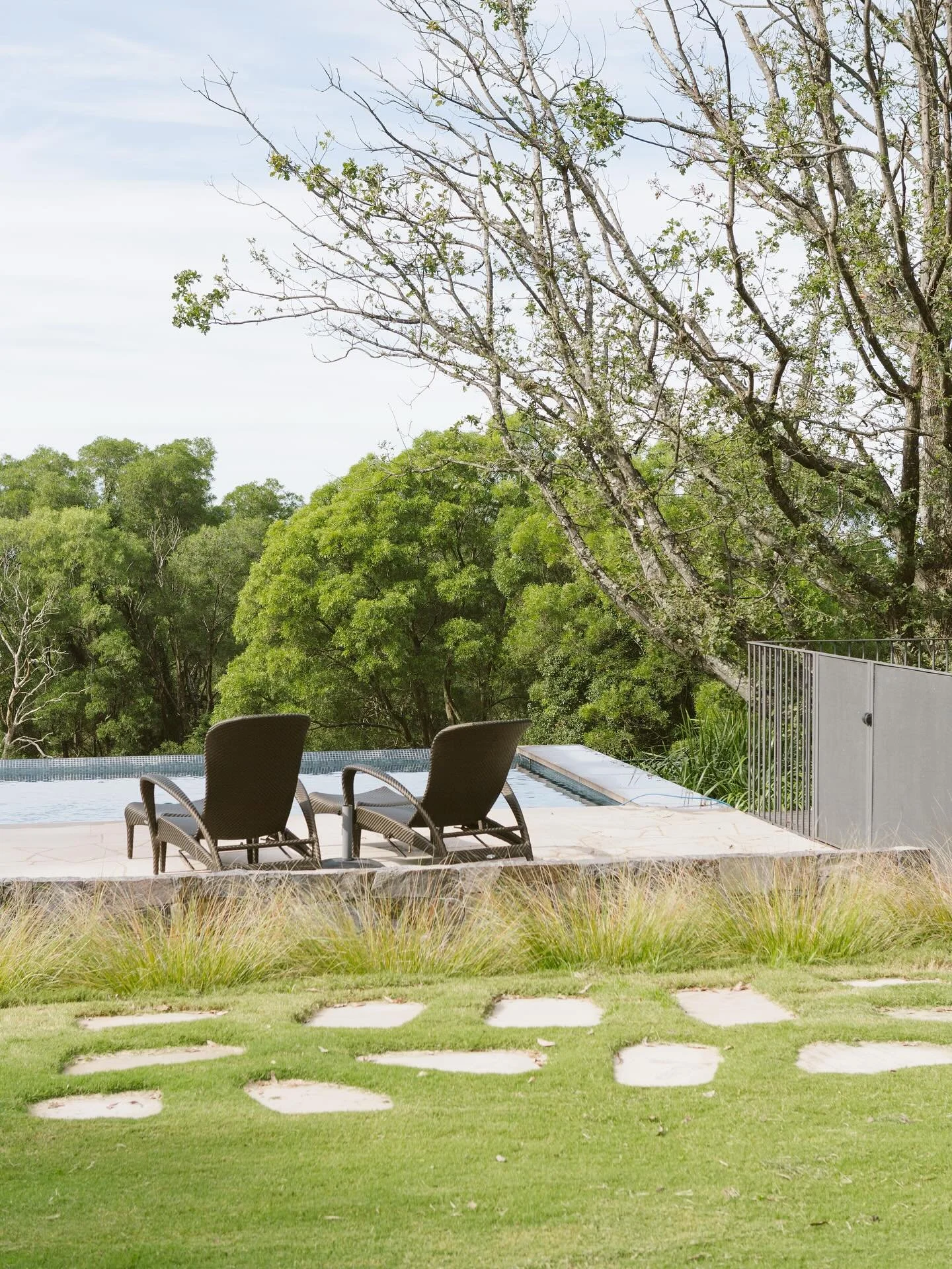 Employing a &lsquo;Ha-Ha Wall&rsquo; concept to hide pool fence &amp; keep views across pool/landscape unimpeded.