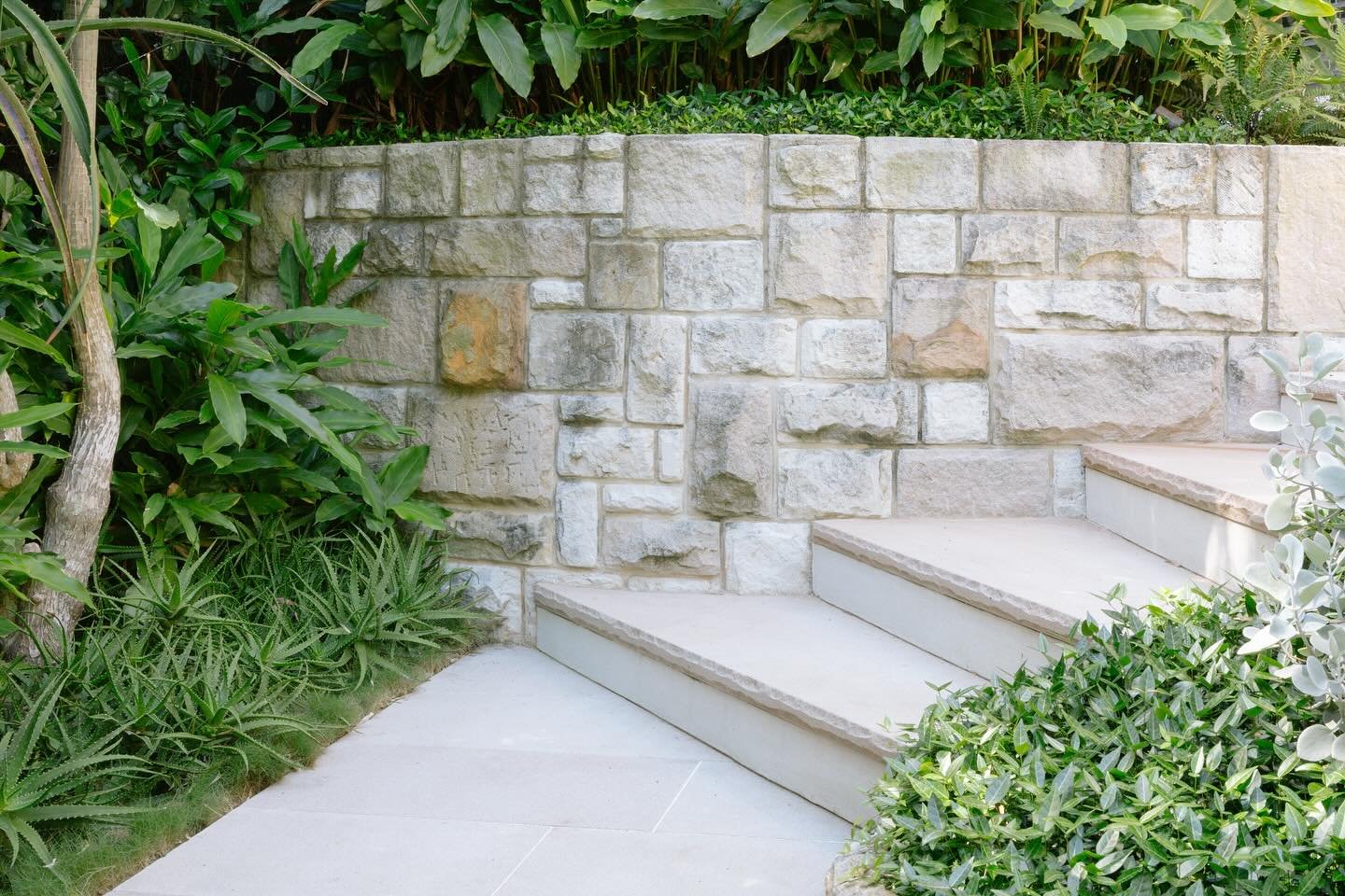 Natural sandstone fringed with layers of green textures.