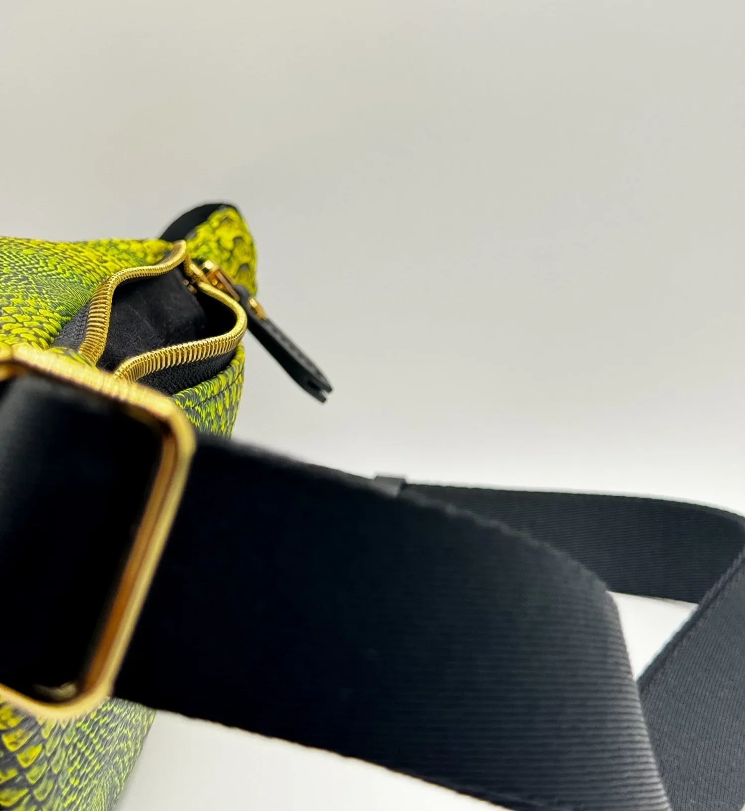 A close-up photo of a textured bright green Fanny Pack on a white backdrop.