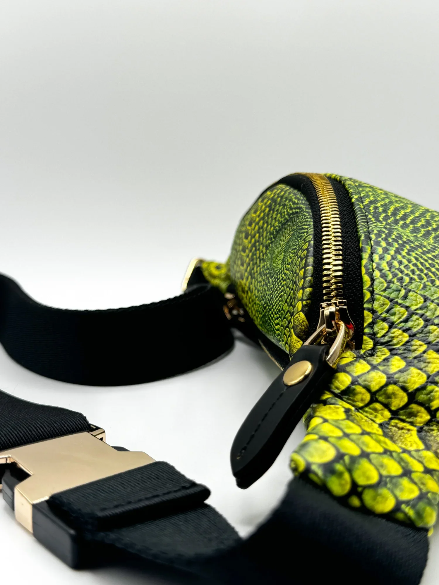 A close-up photo of a textured bright green Fanny Pack on a white backdrop.