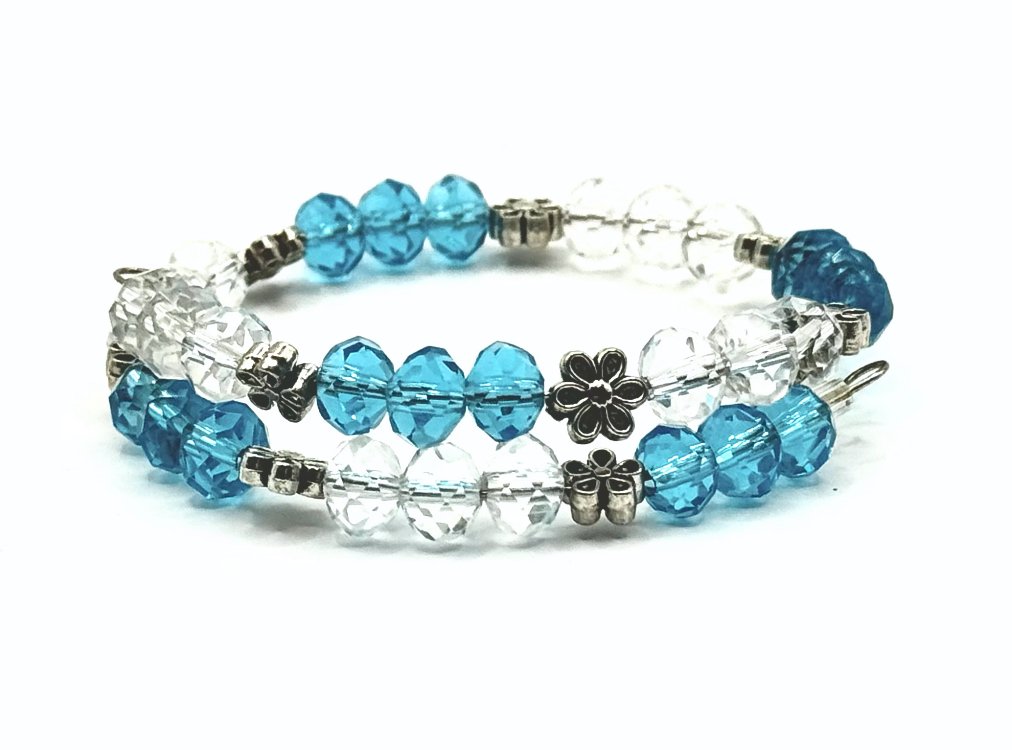 blue and clear trans faceted beads and silver flower spacers.jpg