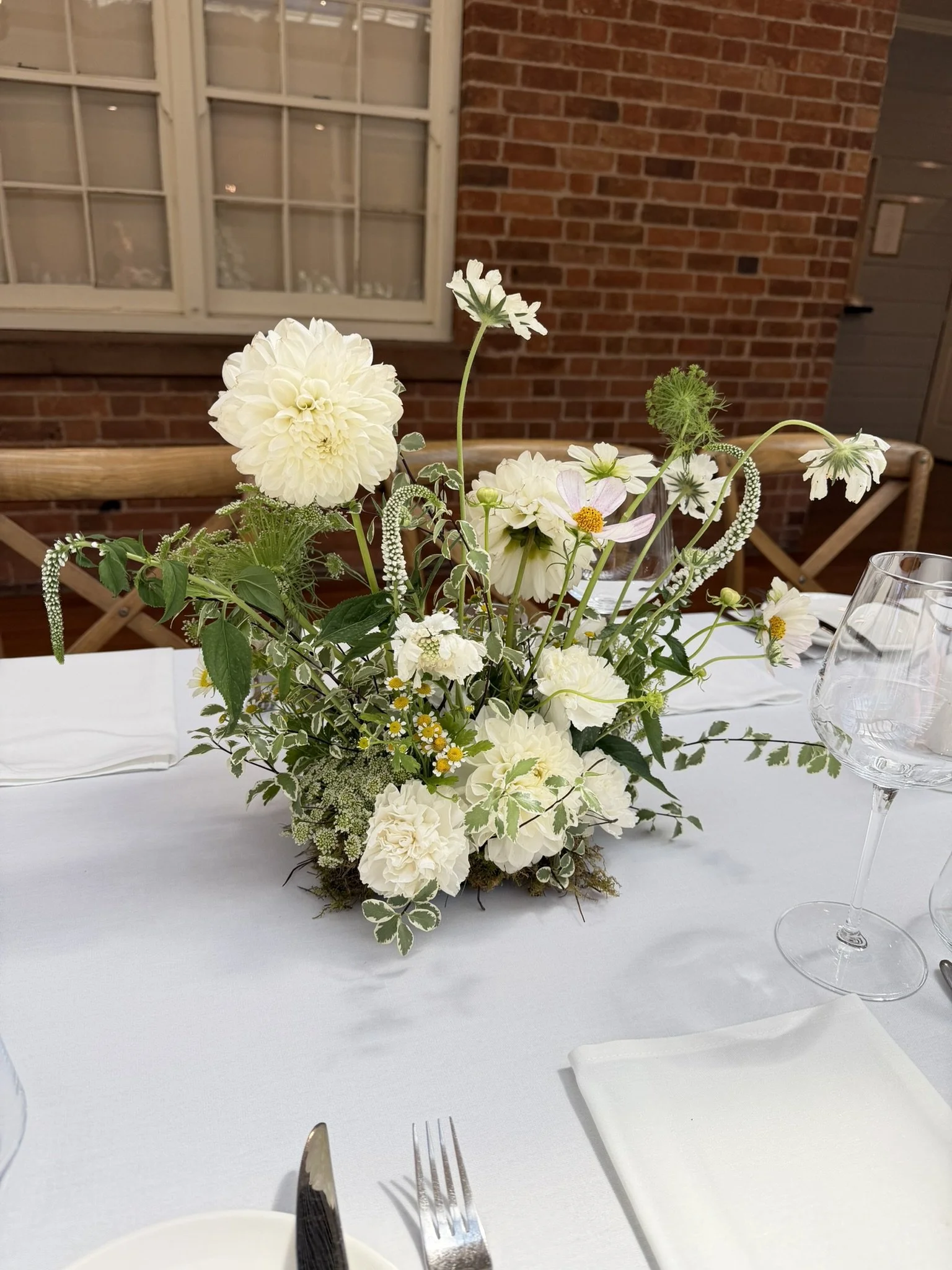 White flowers on a table at a wedding