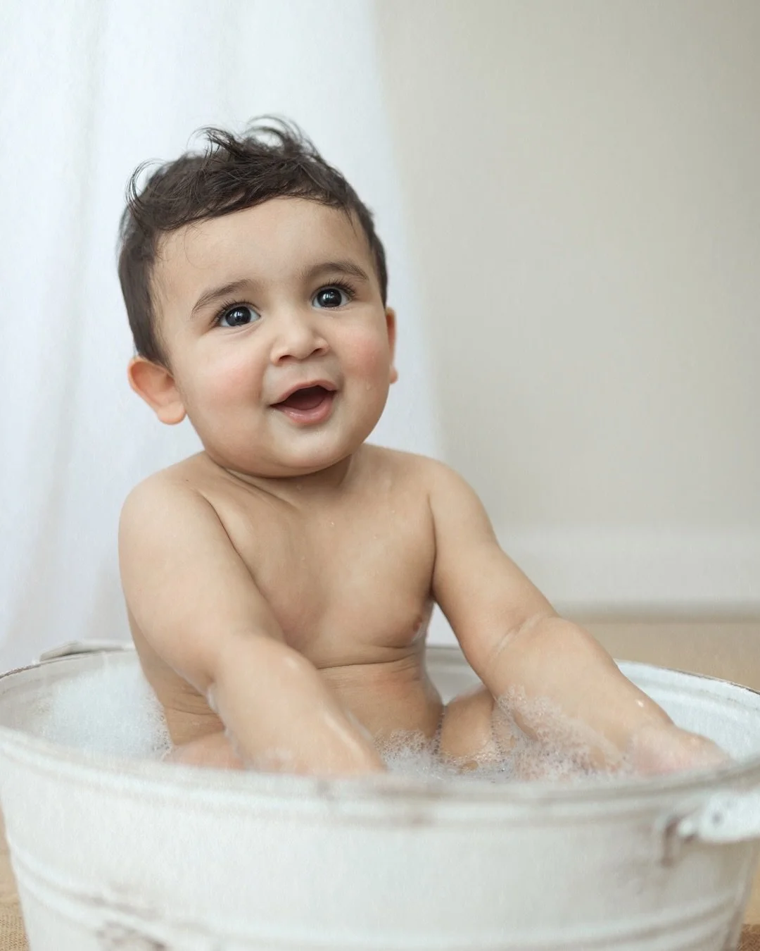 He wasn&rsquo;t having a bad time. 
Foam everywhere, hands splashing, that look on his face like he&rsquo;d discovered the best thing in the world &mdash; which, at this age, he sort of had.
And then dad leaned in, and they were both just beaming.
Th