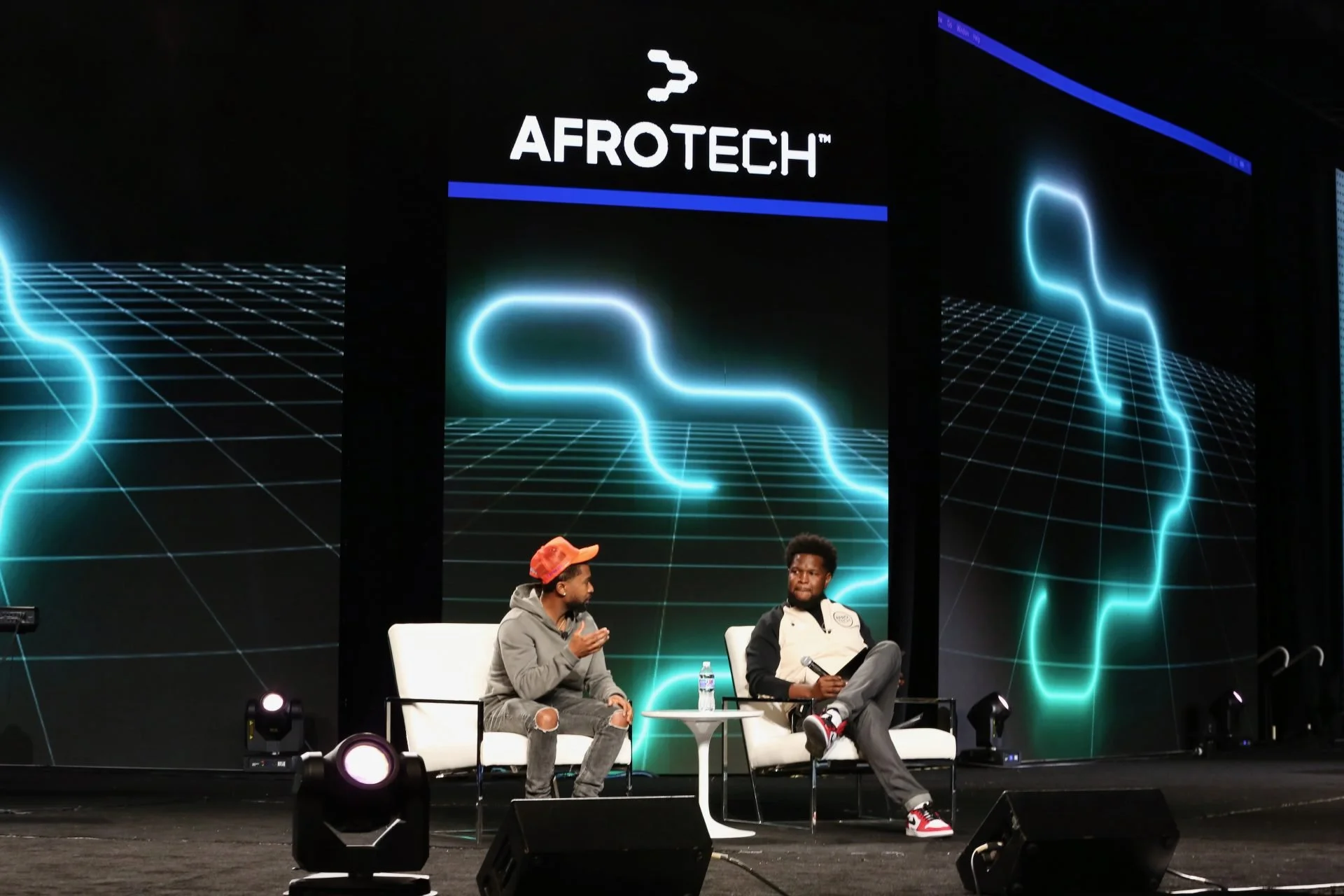 Image of two speakers on stage from 2023 Afro-tech conference