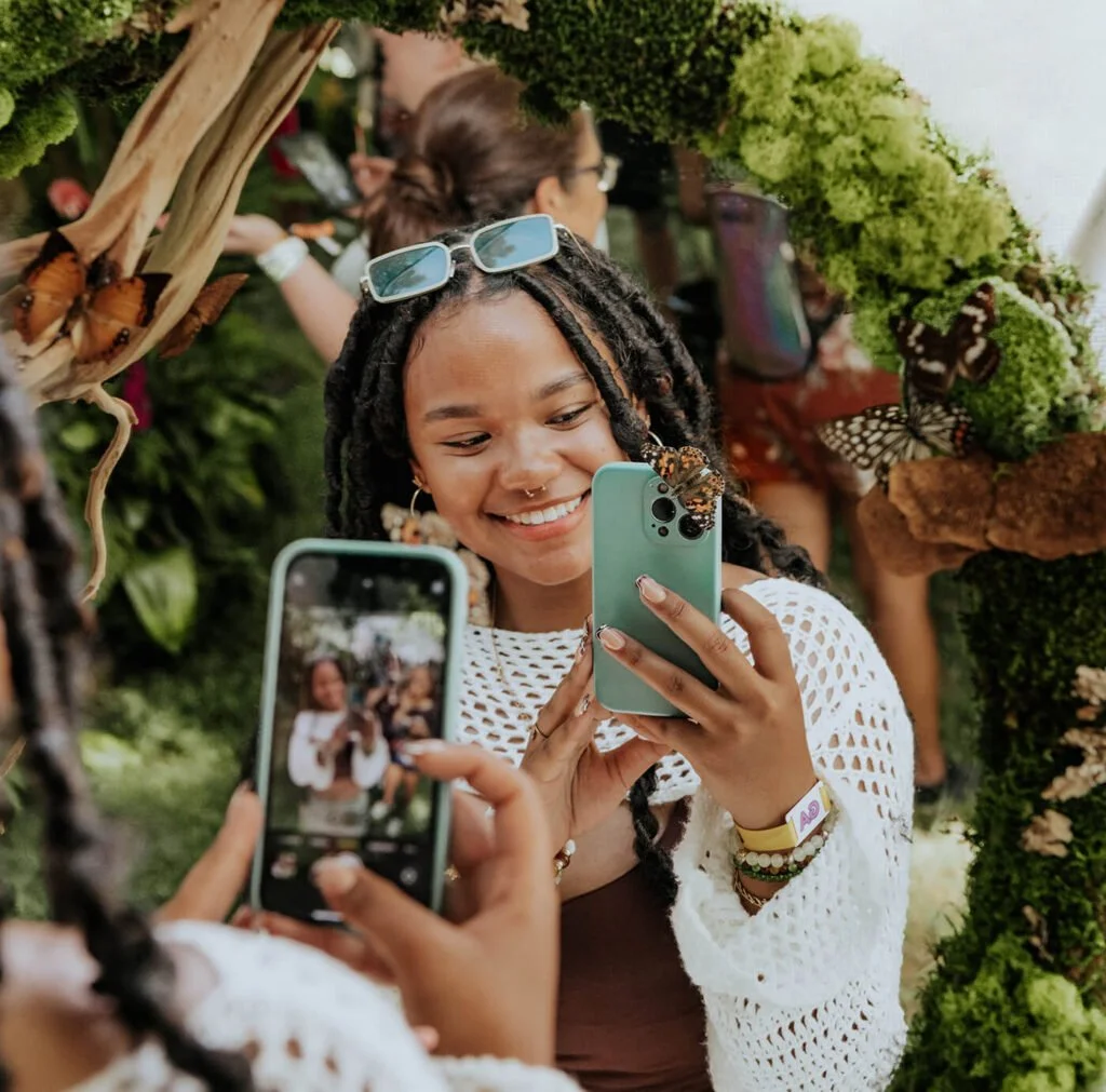   Sol Blume patron taking a selfie in the Butterfly Village, image courtesy of SolBlume.com  