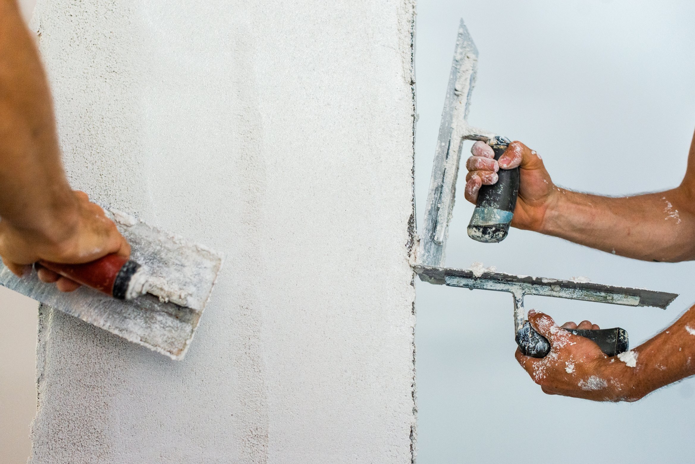 plaster being applied to straw bale panel