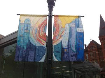 Colorful abstract banner with a cityscape design on a lamppost