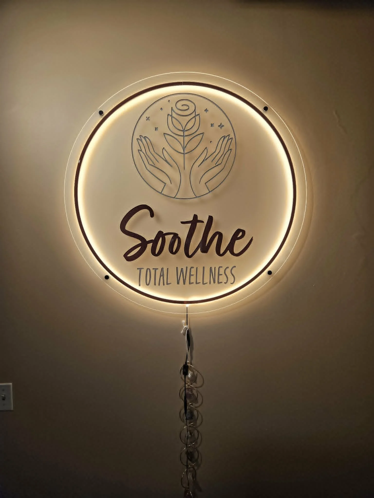 Soothe Total Wellness's logo signage behind theri front desk