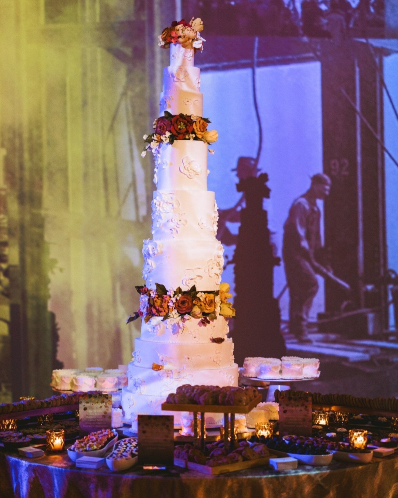 A one-of-a-kind celebration needs a one-of-a-kind cake! This delicately decorated dessert grabs your attention and is just as nice to look at as it is to eat. Paired with miniature cakes and treats, the dessert table provides guests with a treasure t