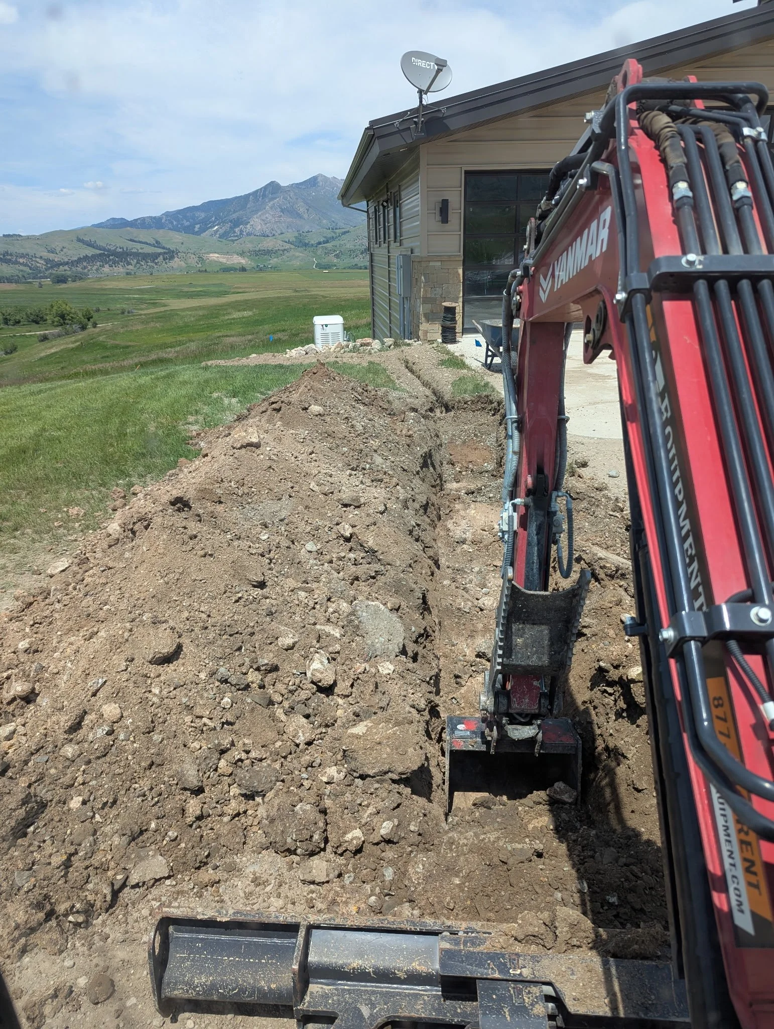 Raised garden beds and privacy fencing in a modern backyard design in Big Sky.