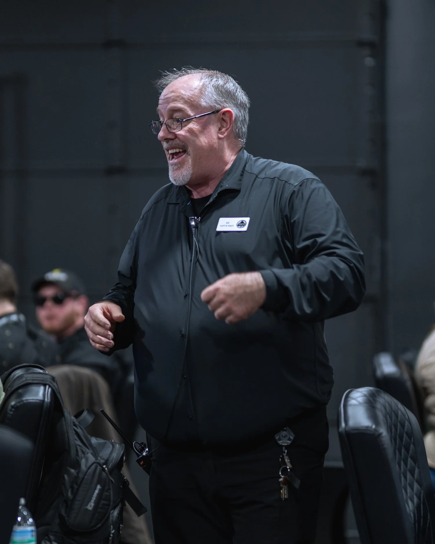 A Barrel Social staff member chatting with patrons and helping on the poker room floor.