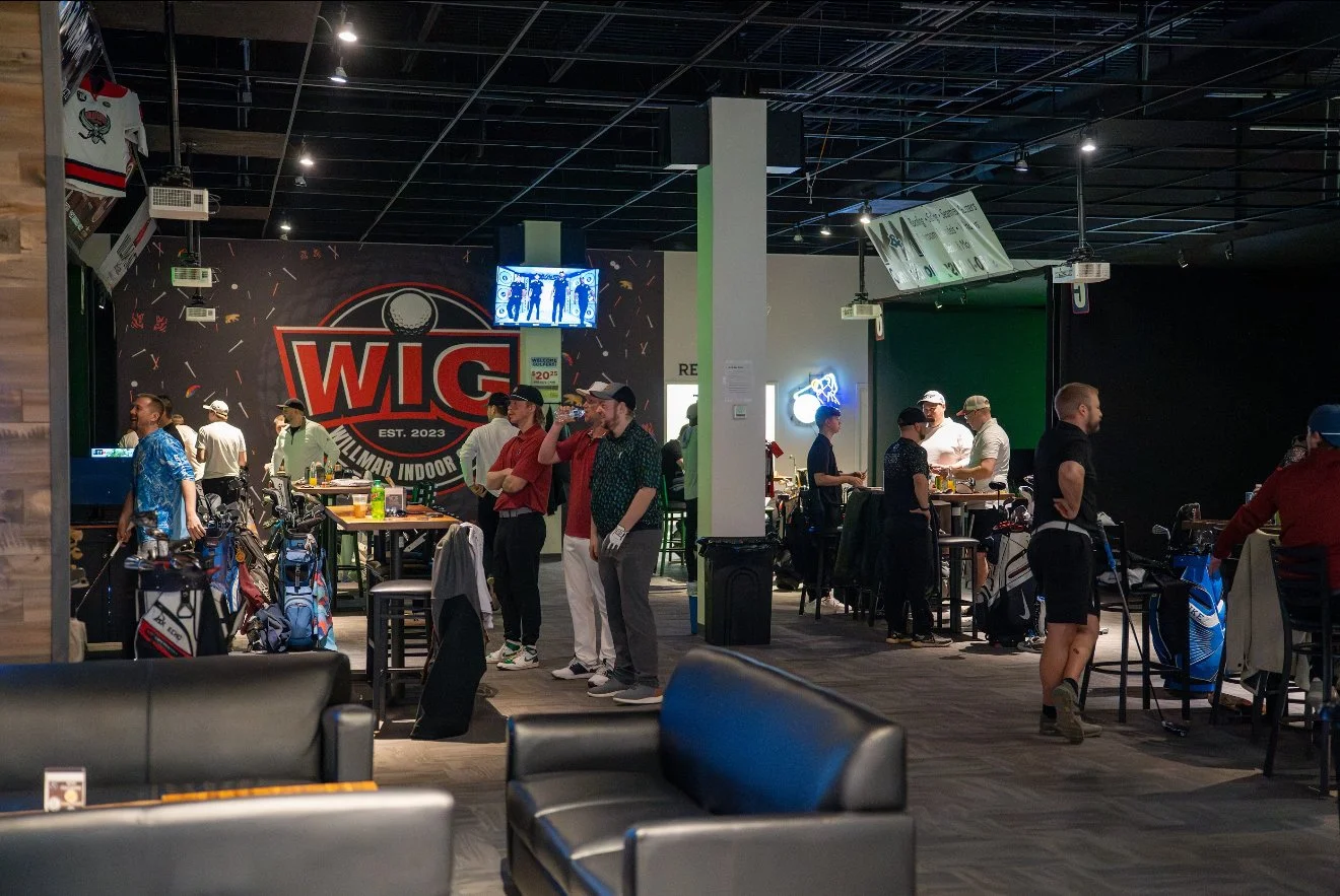 Friends playing in WIG’s golf simulator bays
