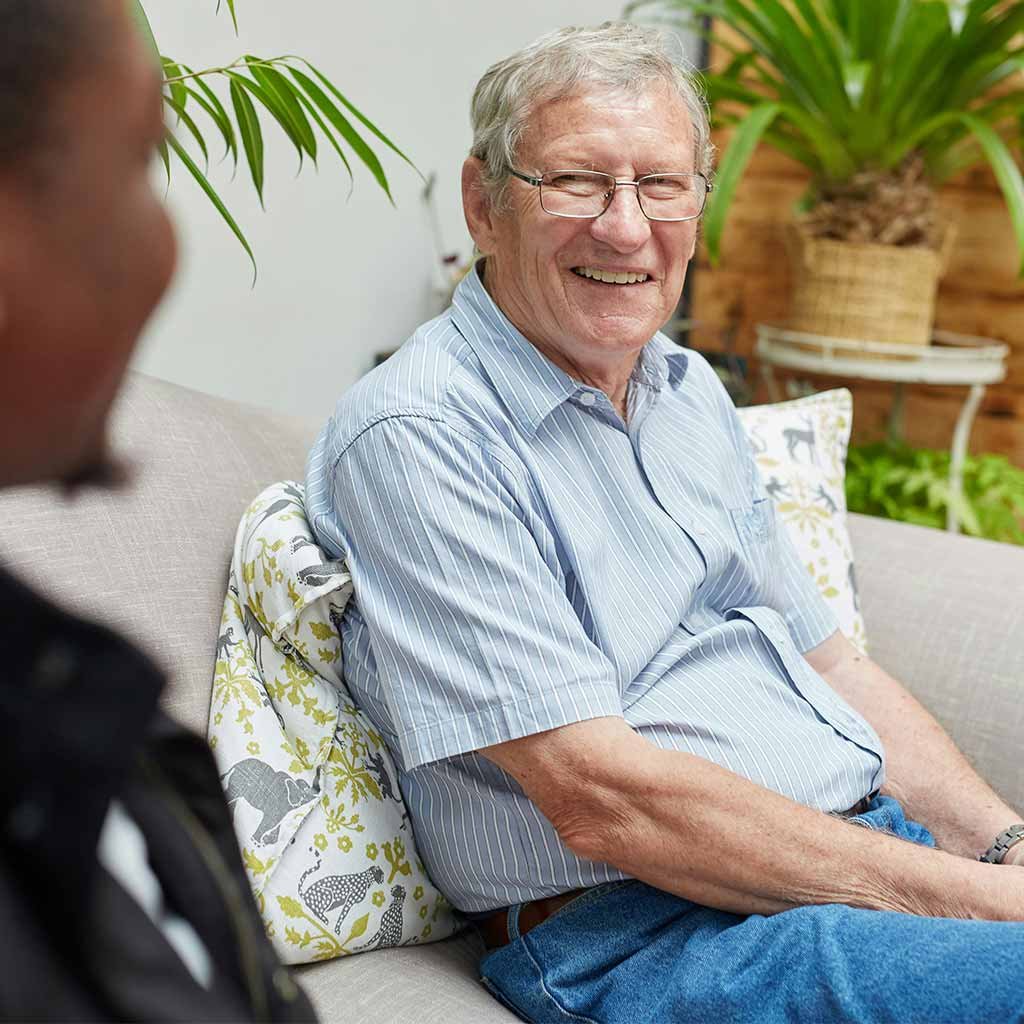 elderly man sitting on couch