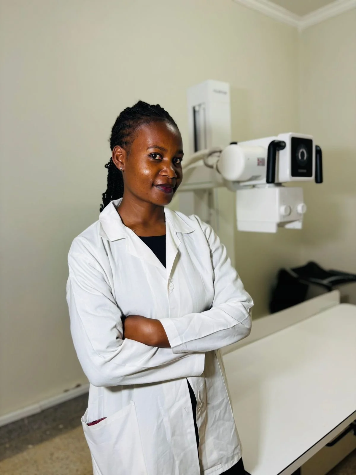 Irene stands beside a radiography machine.