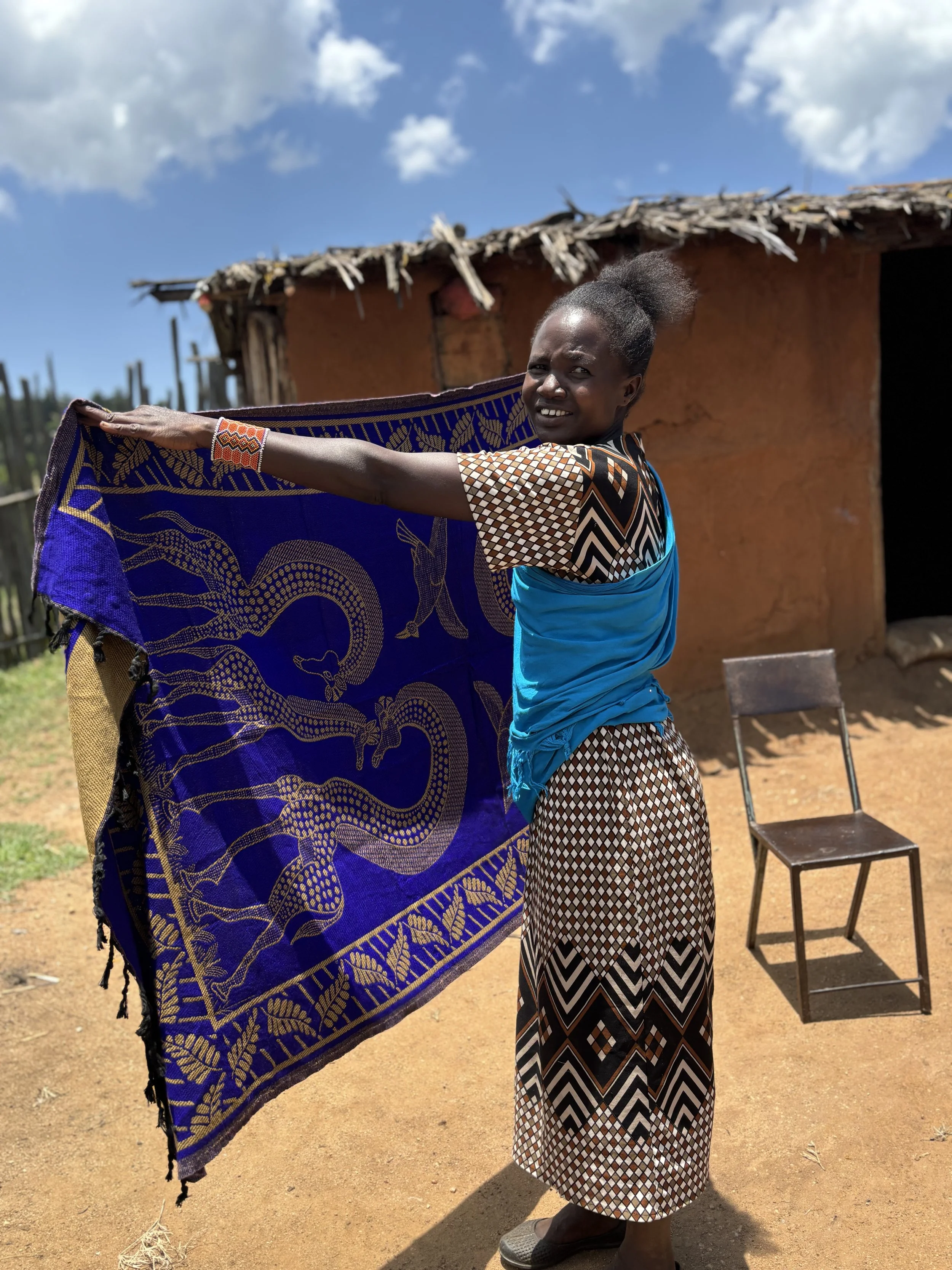 A parent showing off her traditional blankets business