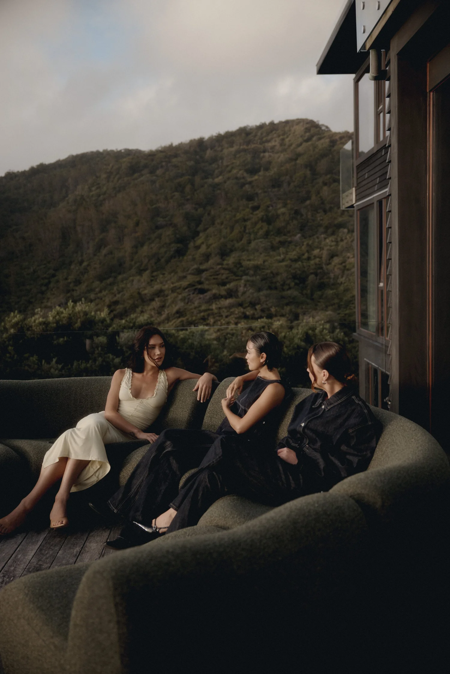 Three women on the deck sofa during the Glassons AW25 shoot