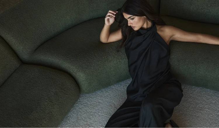 Moochi campaign shoot, model reclining on the green sofa