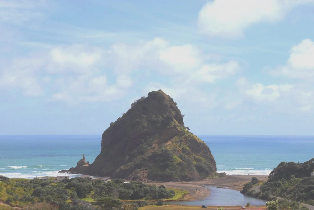 The stream meeting the sea at Piha