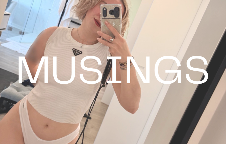 A woman in a fitting room taking a mirror selfie with her phone, wearing a white sleeveless top and white underwear, with the word 'MUSINGS' overlaid on the image.