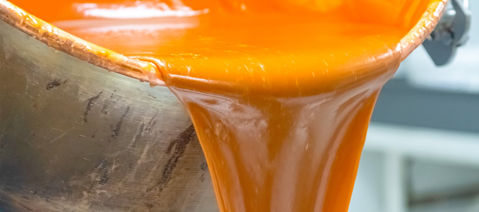 Close-up of traditional handmade fudge being poured from a copper pot, with the words 'Traditional Handmade Fudge' overlaid.