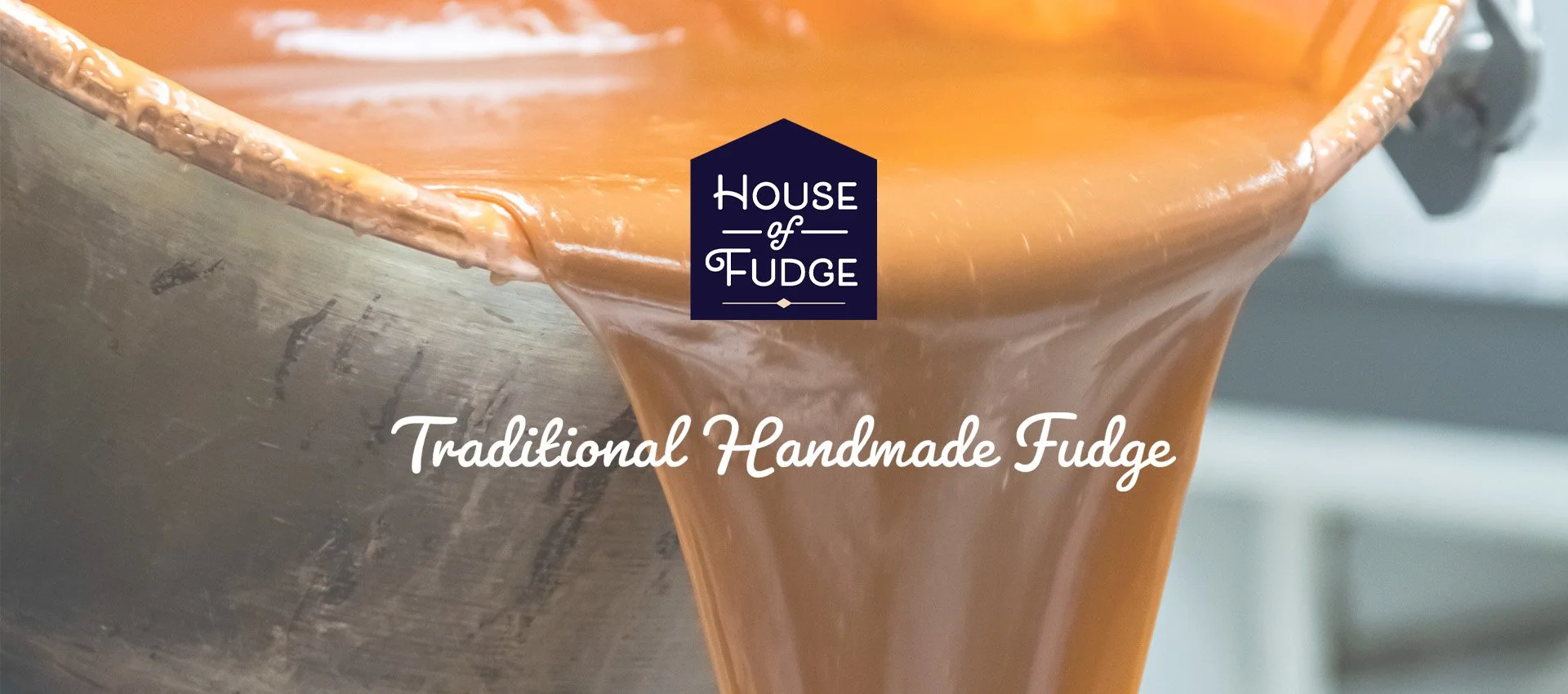 Close-up of traditional handmade fudge being poured from a copper pot, with the words 'Traditional Handmade Fudge' overlaid.
