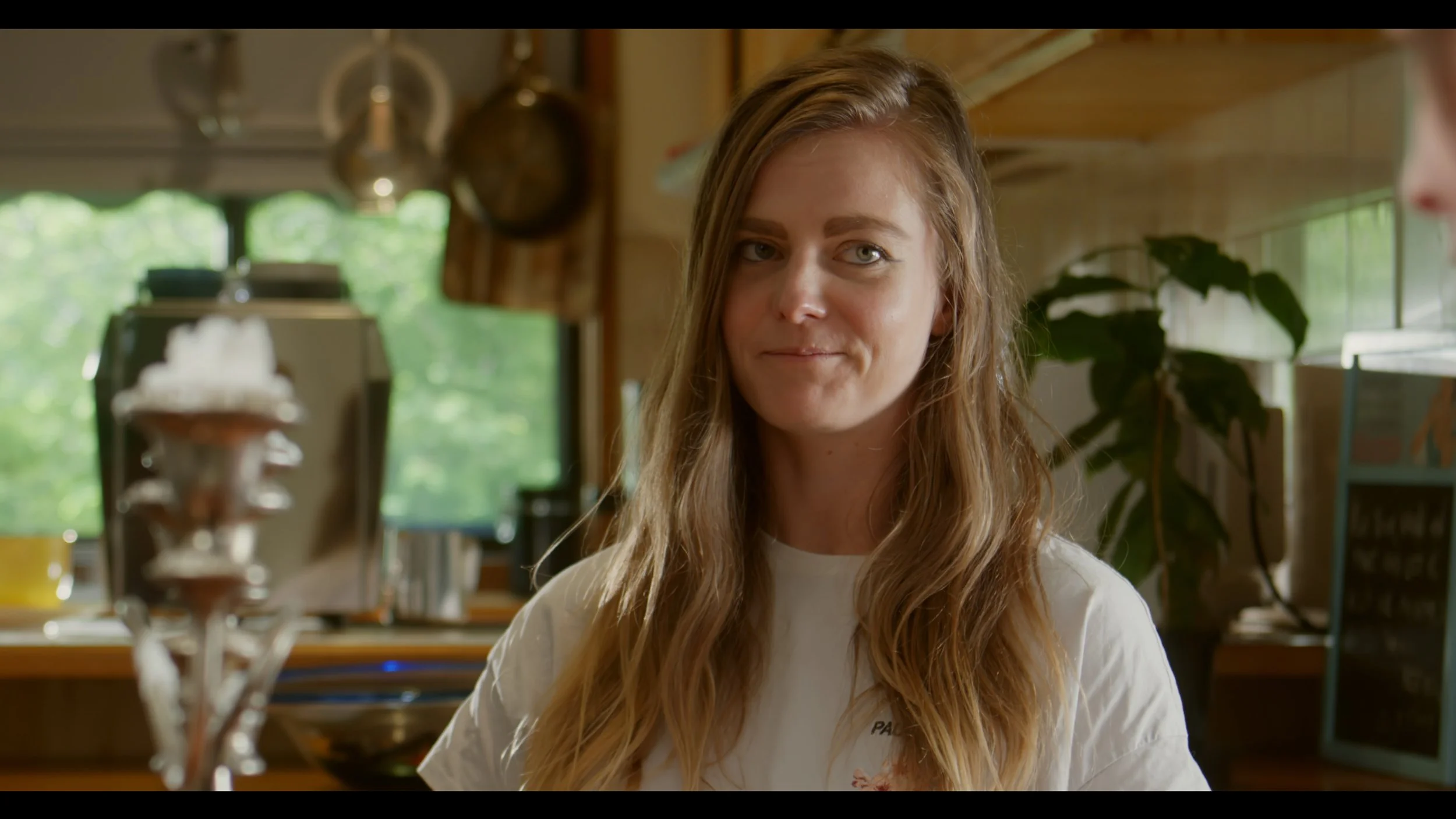 Woman with long hair in a kitchen setting with blurred background